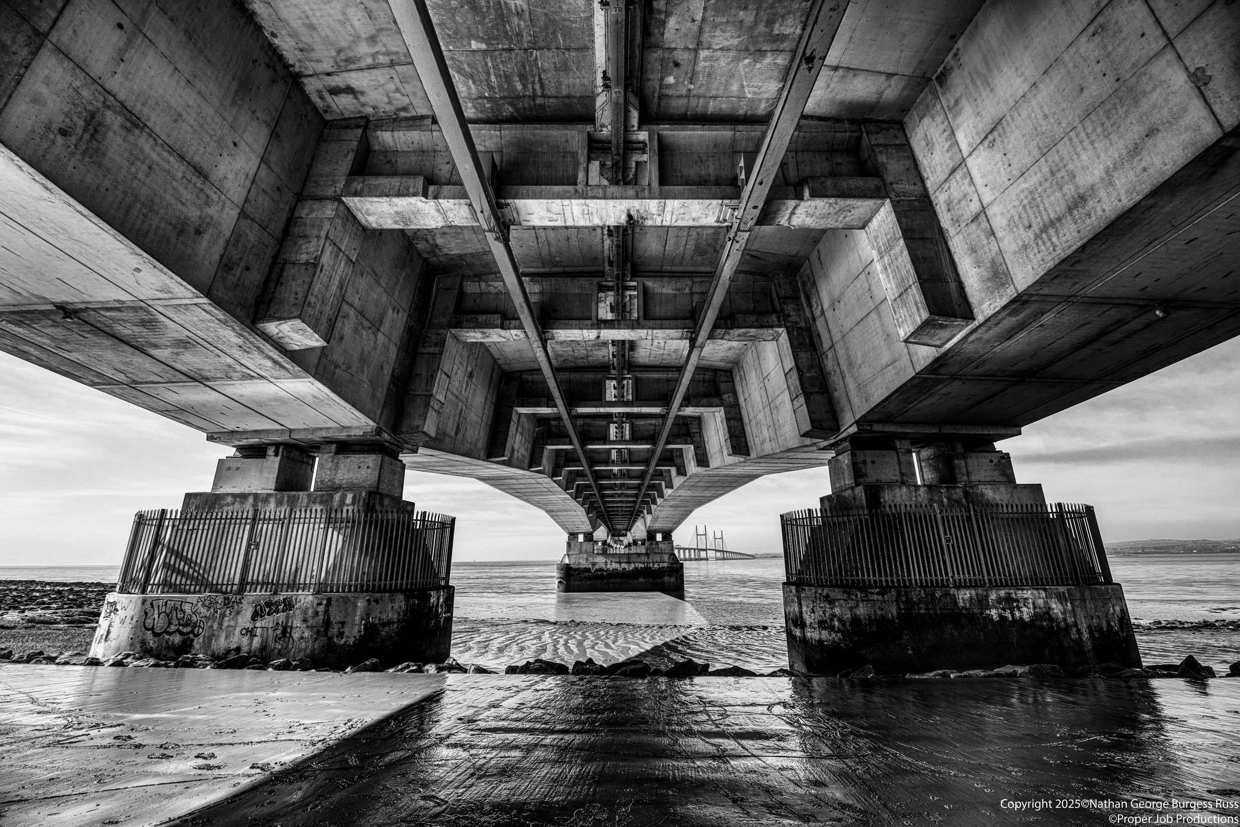 The underside of the Prince of Wales Bridge (Pont Tywysog Cymru), formerly known as the Second Severn Crossing (Ail Groesfan Hafren). 

The Bridge opened in 1996 to carry the M4 over the River Severn Estuary, to relieve the traffic on the first Sever