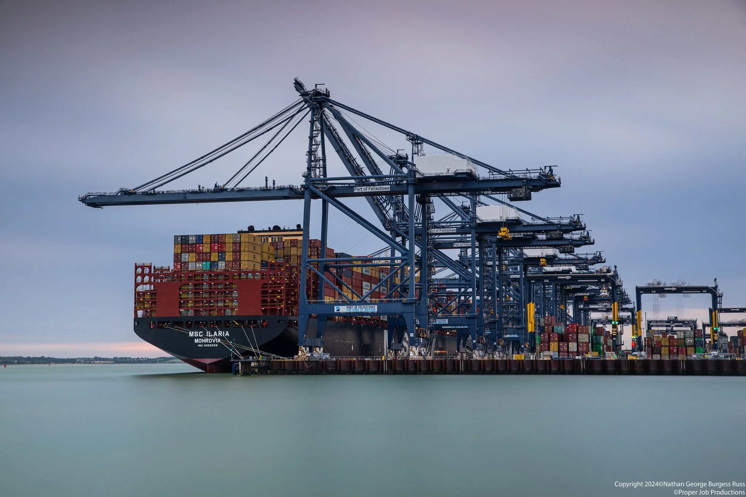 MSC Ilaria and OOCL Felixstowe in the Landguard terminal in the Port of Felixstowe during blue hour.