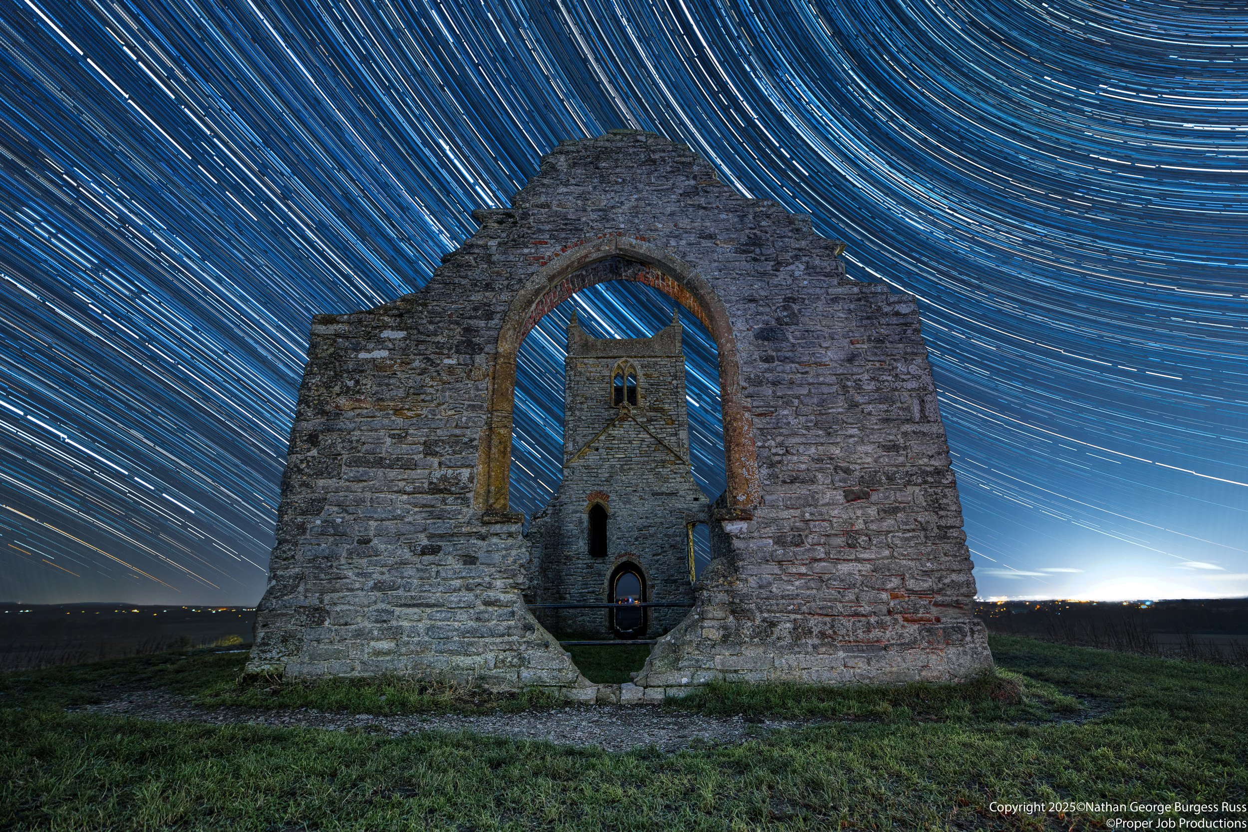 A star trail of the ruins of Saint Michaels Church from the window end.

Saint Michaels was originally built on Burrow Mump sometime in the mid 1400's, above the hamlet of Burrowbridge. In the English Civil Wars it was used as a sanctuary for royalis