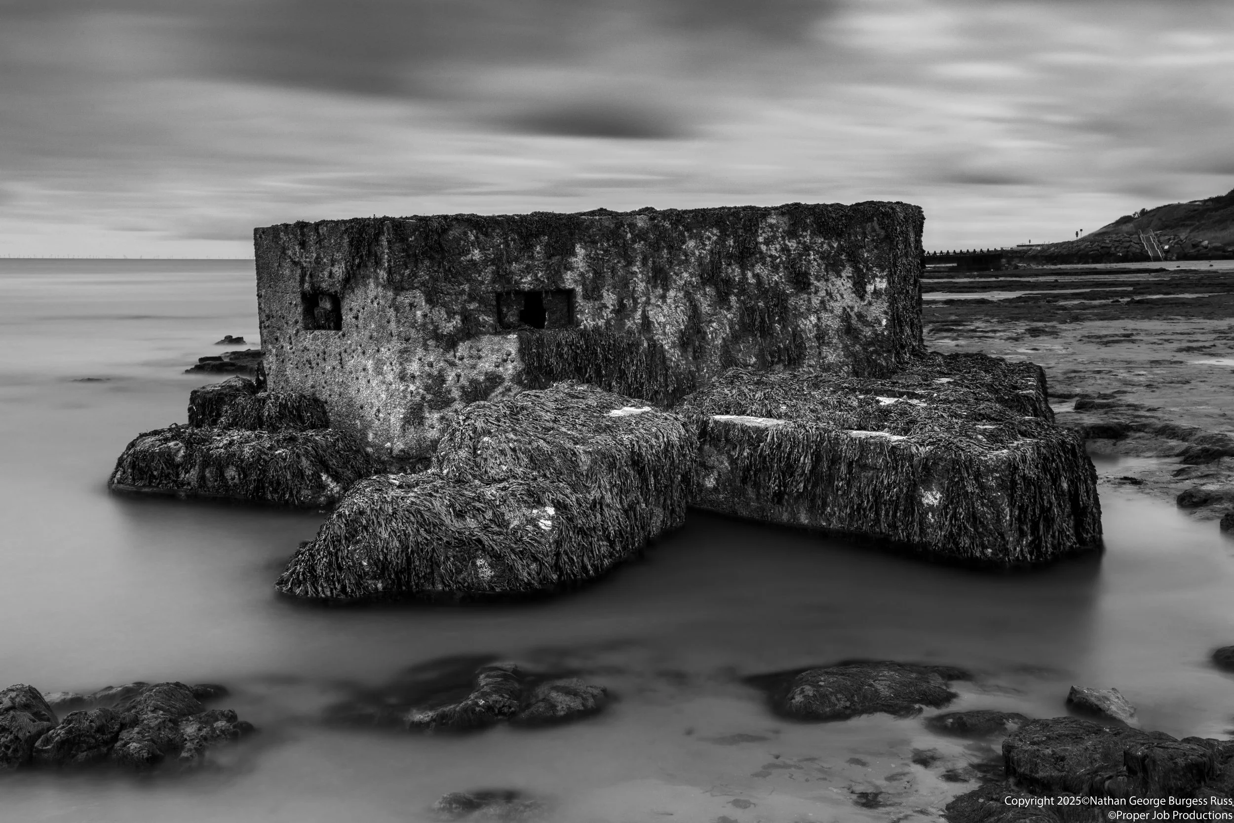 A rare Type 27 FW3 Pill Box on the Naze Beach with the North Sea coming in.

This Type 27 FW3 Pill Box was originally built ontop of the cliffs near The Naze Tower in 1940, in the years since North Sea Coastal erosion has caused the pillboxes to fall