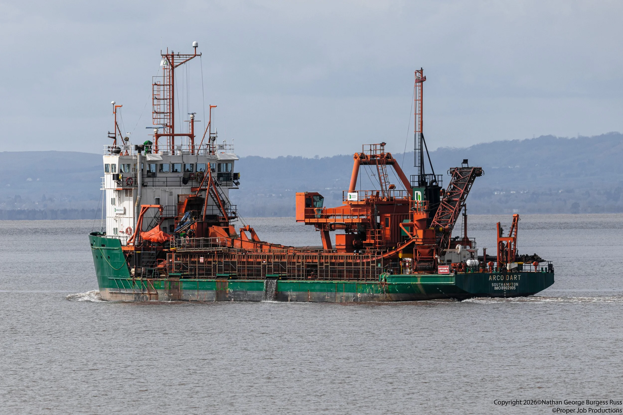 The Arco Dart going past Battery Point in Portishead. The Arco Dart is a Bureau Veritas Hopper Dredger built in 1990 by Royal IHC at the Sliedrecht shipyards. She was owned by Hanson Aggregates Marine, but now operates for Heidelberg Materials.
