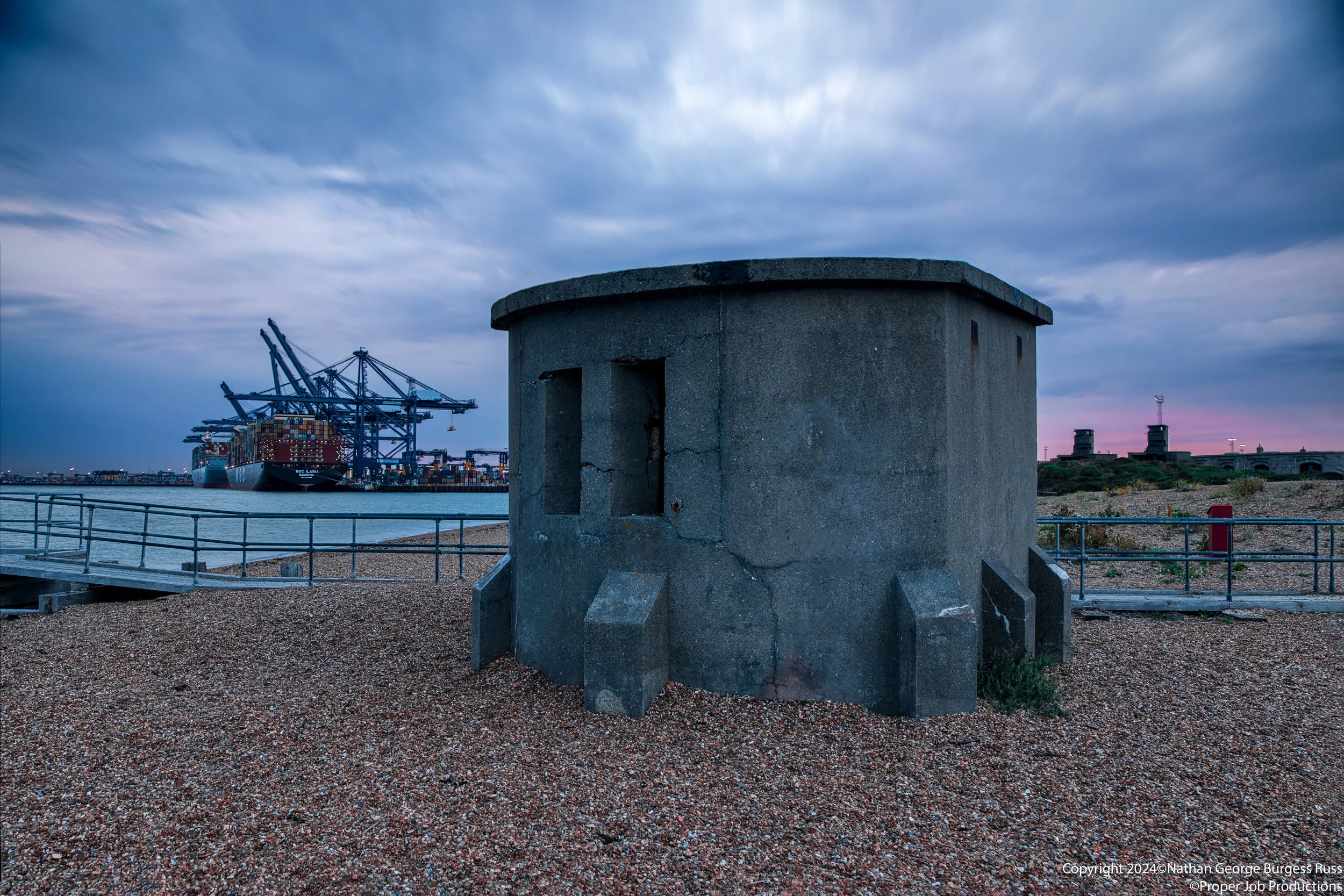 Pillbox on Landguard Point keeping guard over the channel into Felixstowe and Harwich ports at evening blue hour