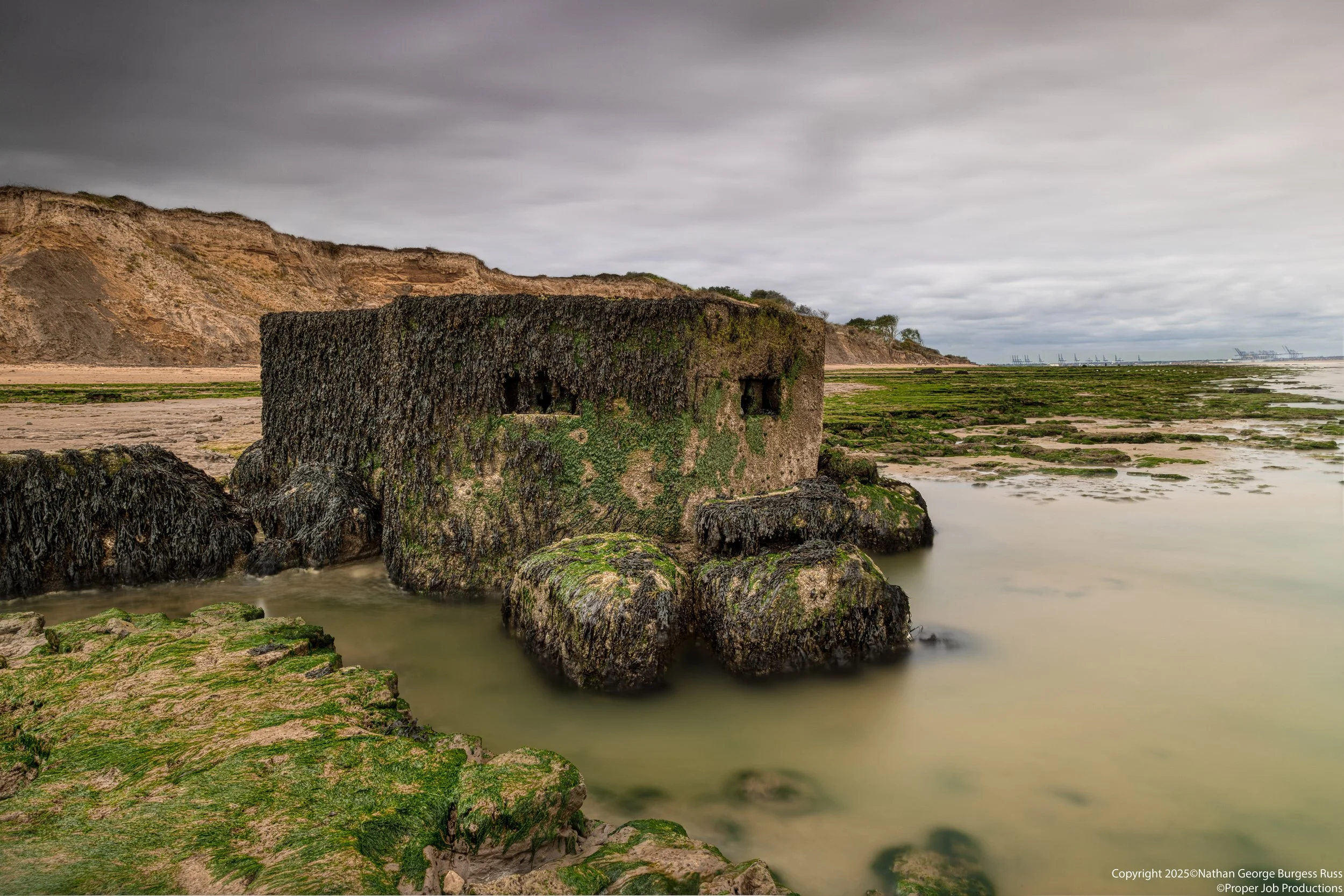 A rare Type 27 FW3 Pill Box on the Naze Beach with the North Sea coming in.

This Type 27 FW3 Pill Box was originally built ontop of the cliffs near The Naze Tower in 1940, in the years since North Sea Coastal erosion has caused the pillboxes to fall
