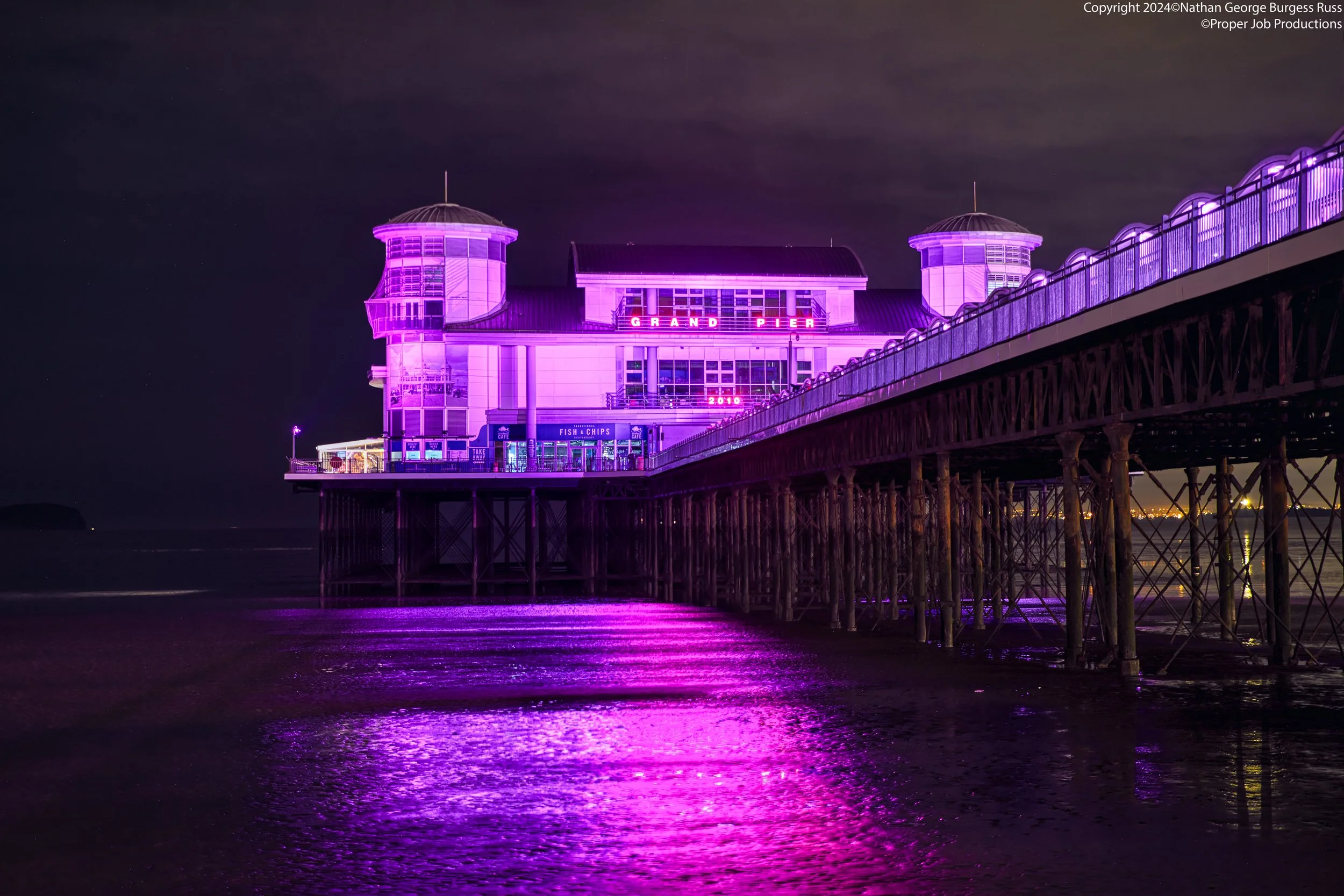 Weston-Super-Mare Grand Pier - Night

The Grand Pier is a classical example of late victorian/early edwardian pleasure pier, and the end of the pier is the third pavilion built at the far end of the pier, with the first being destroyed by fire on Jan