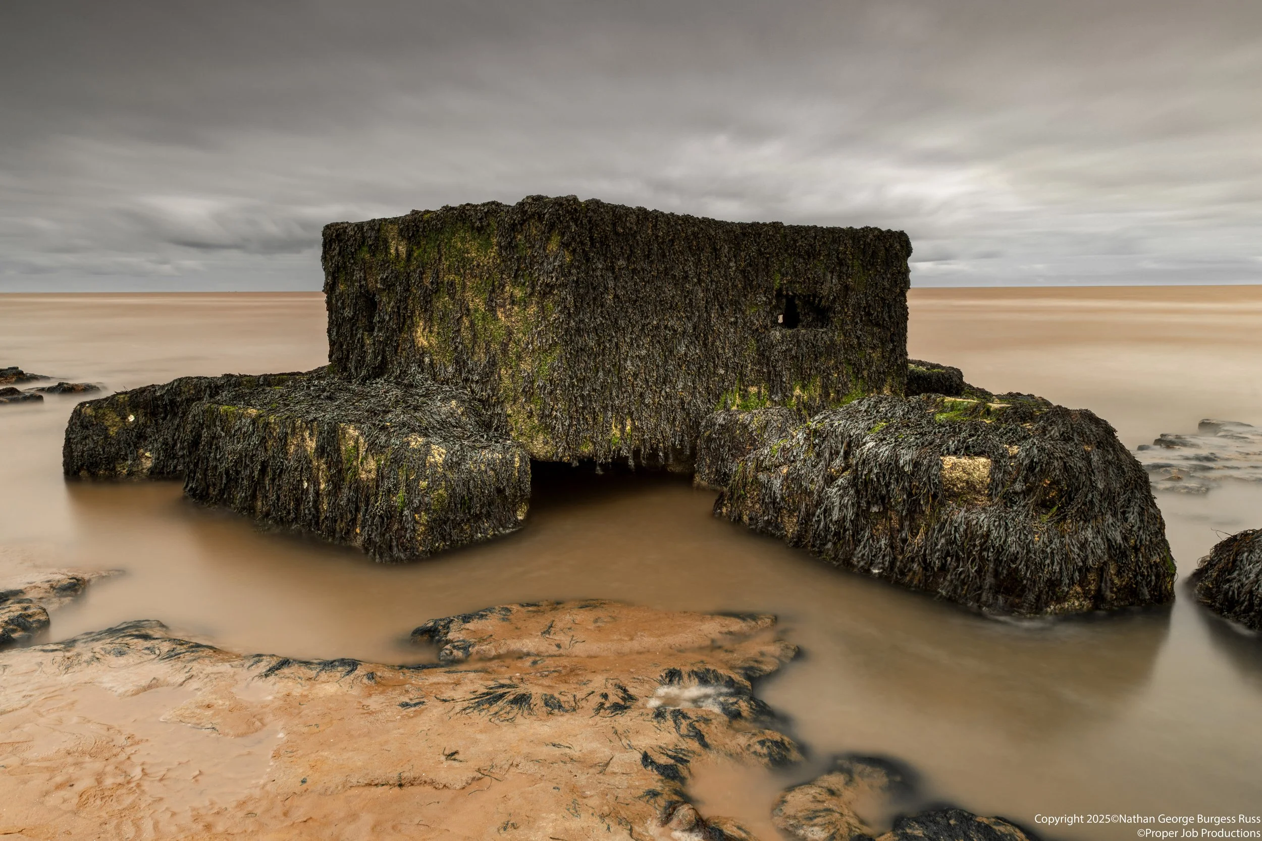 A rare Type 27 FW3 Pill Box on the Naze Beach with the North Sea coming in.

This Type 27 FW3 Pill Box was originally built ontop of the cliffs near The Naze Tower in 1940, in the years since North Sea Coastal erosion has caused the pillboxes to fall