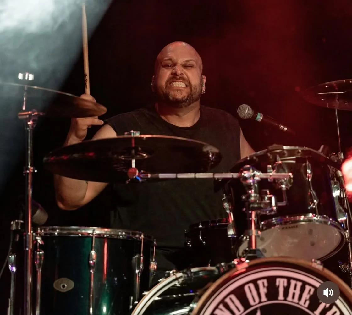 PH Teixeira performing live behind an acoustic drum kit