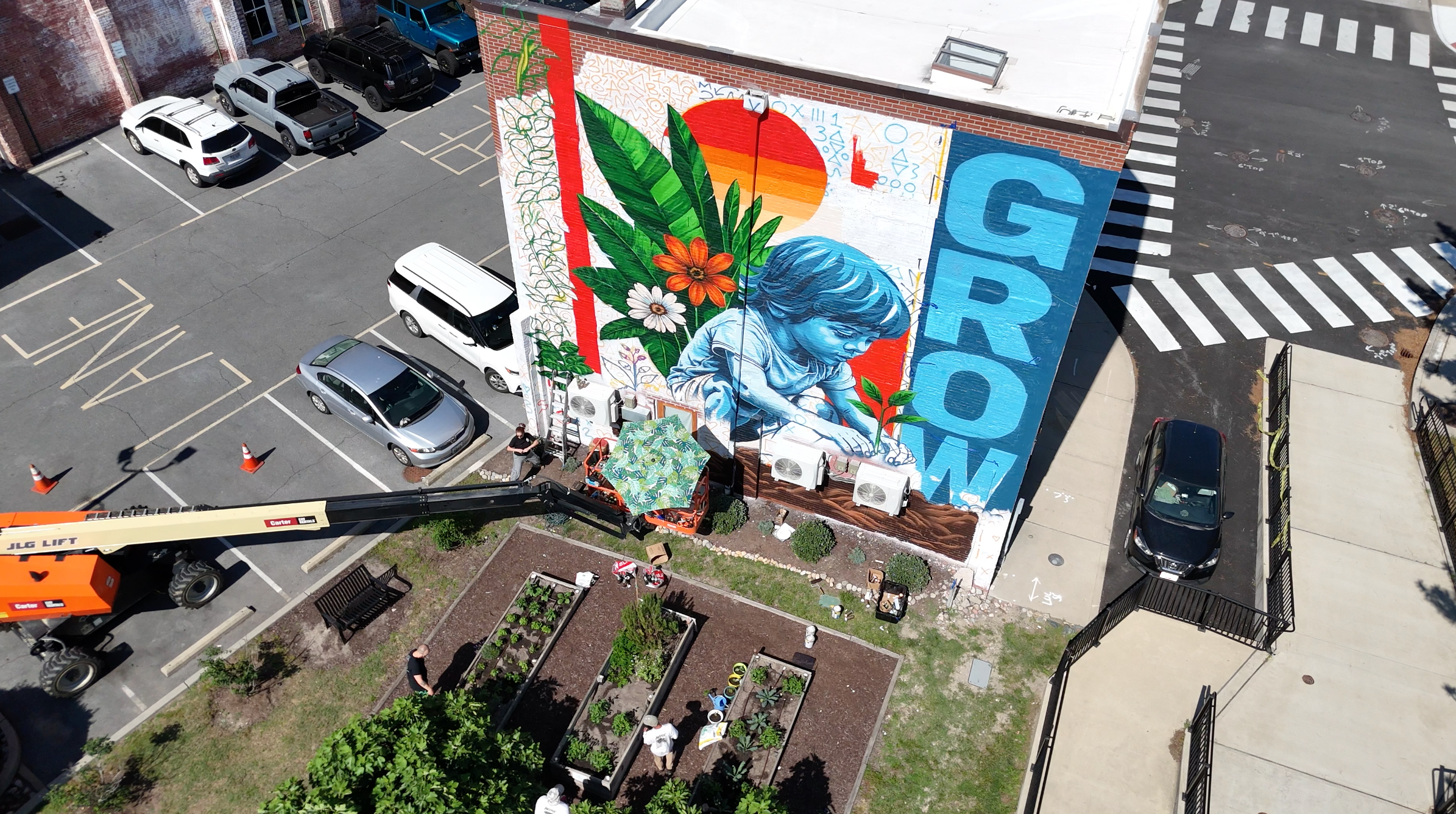 Aerial view of the GROW mural and boom lift during installation in Downtown Salisbury Maryland