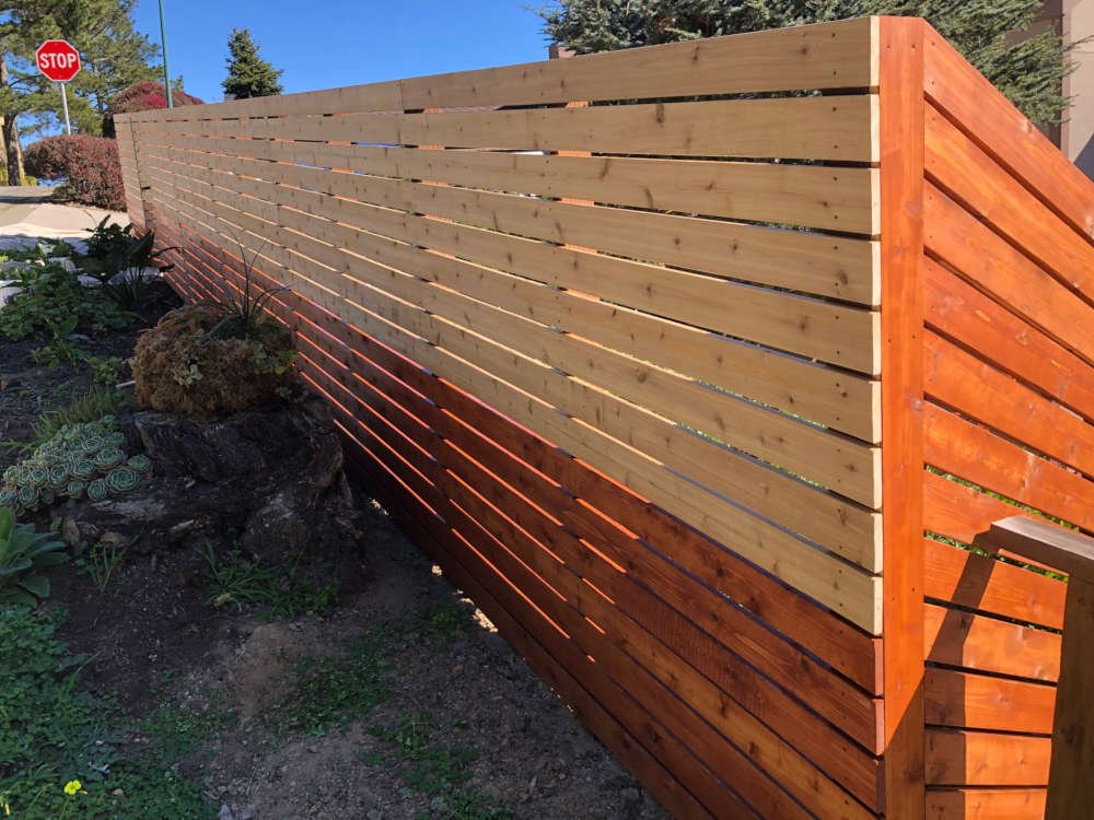 Cedar Fence Being Stained 