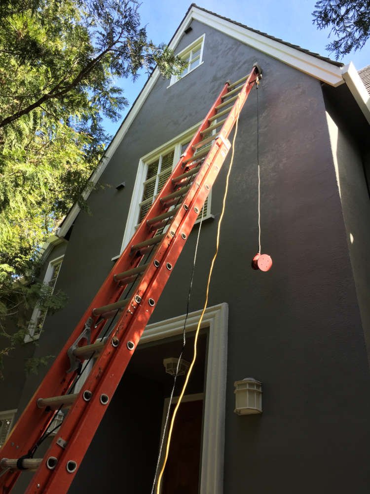 Grey Stucco House With Ladder 