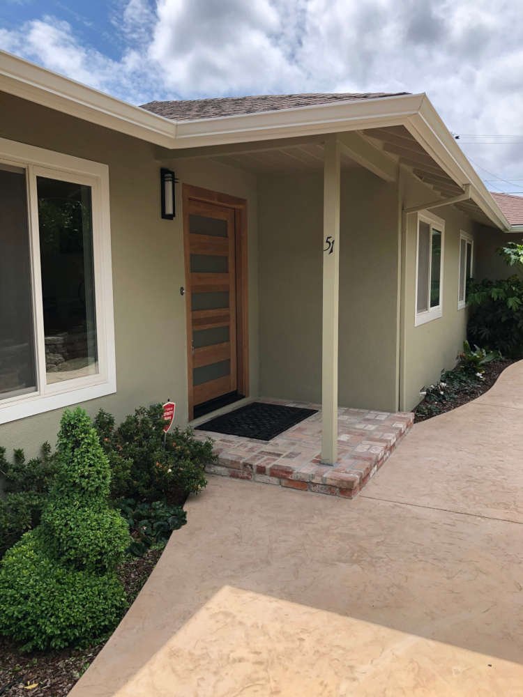 Green House With Wooden Front Door