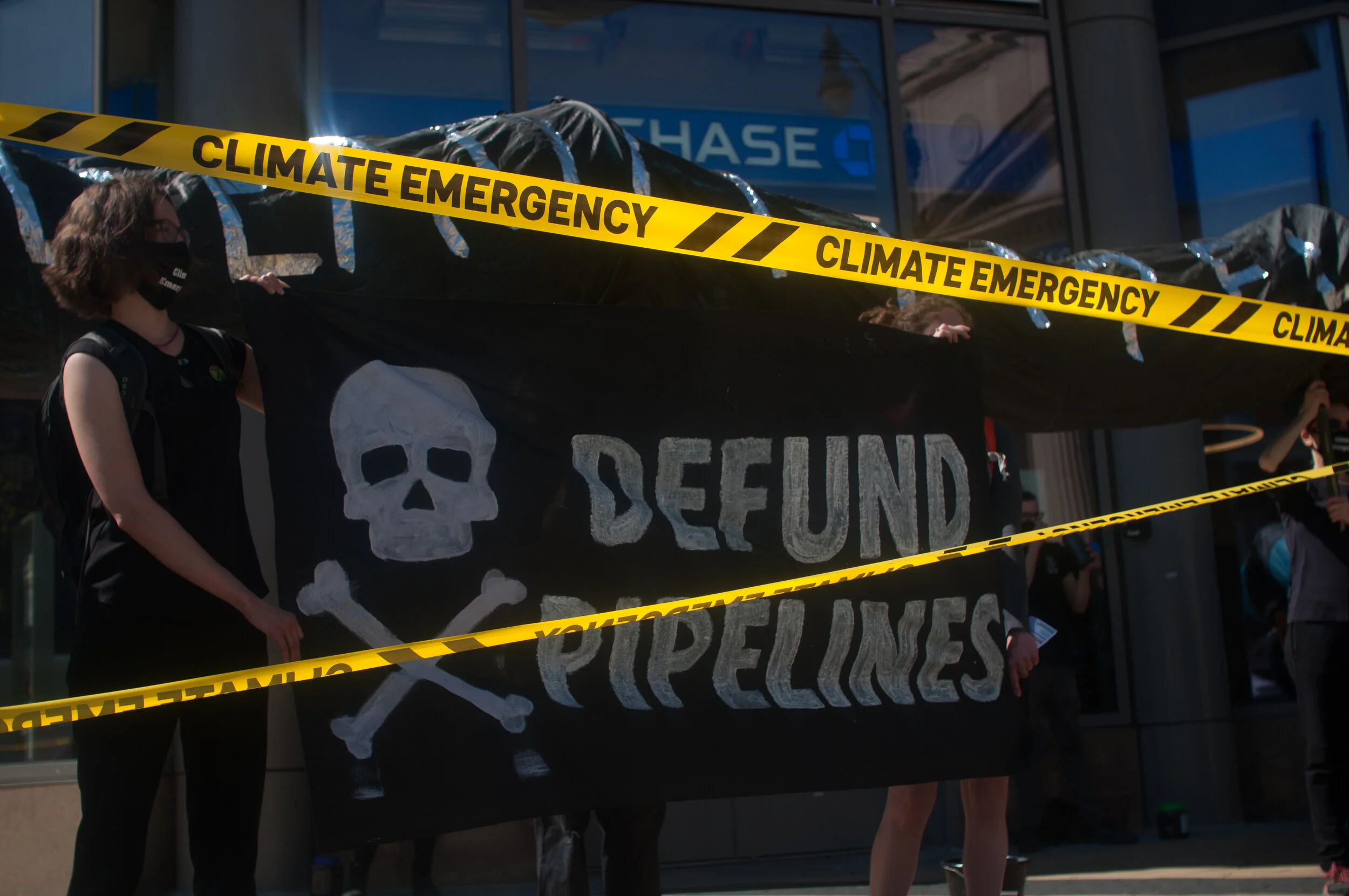 XR Rebels Spill Oil Outside DC Bank Funding Toxic Line-3 Pipeline