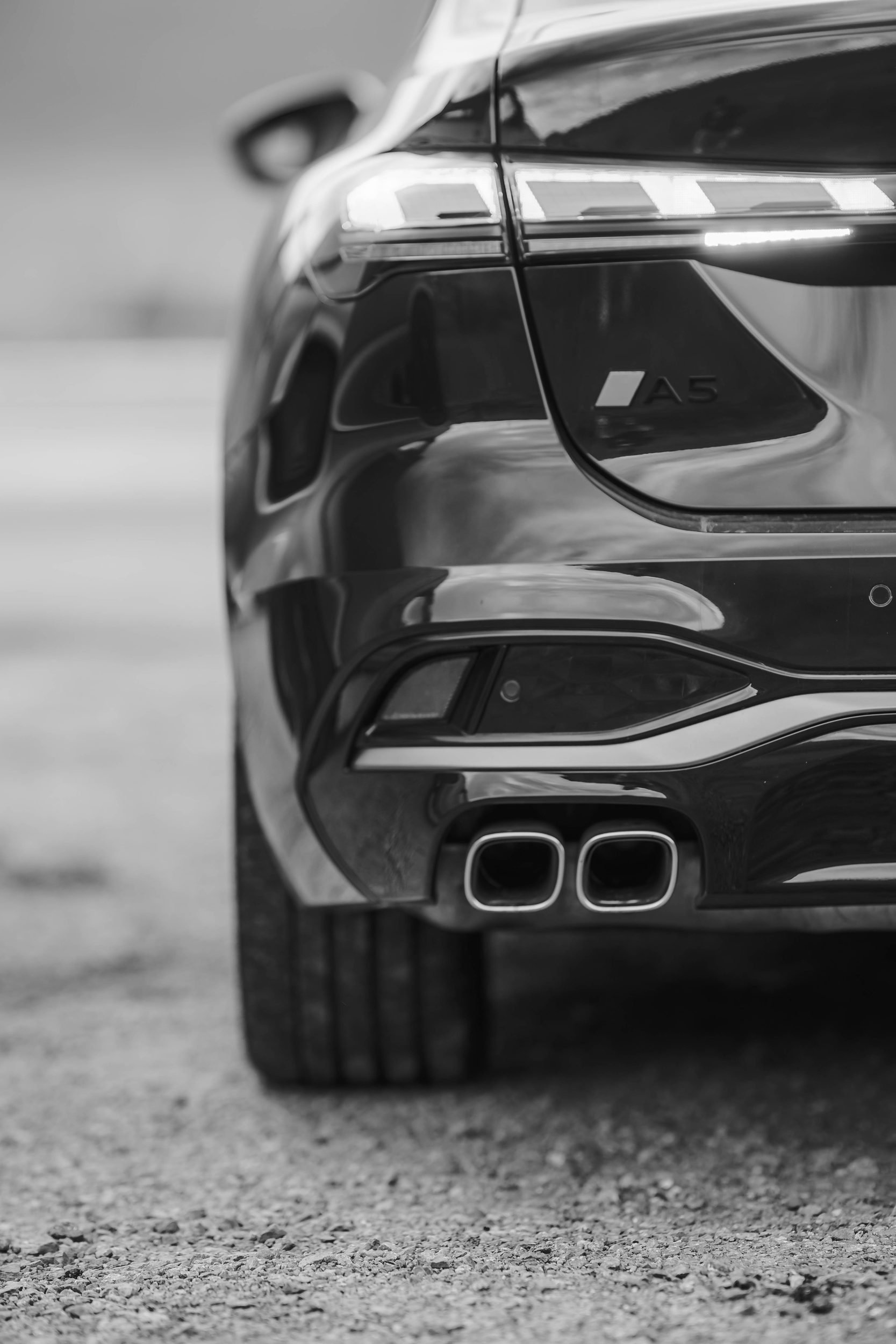 Rear detail of a black Audi with quad exhausts, Wales