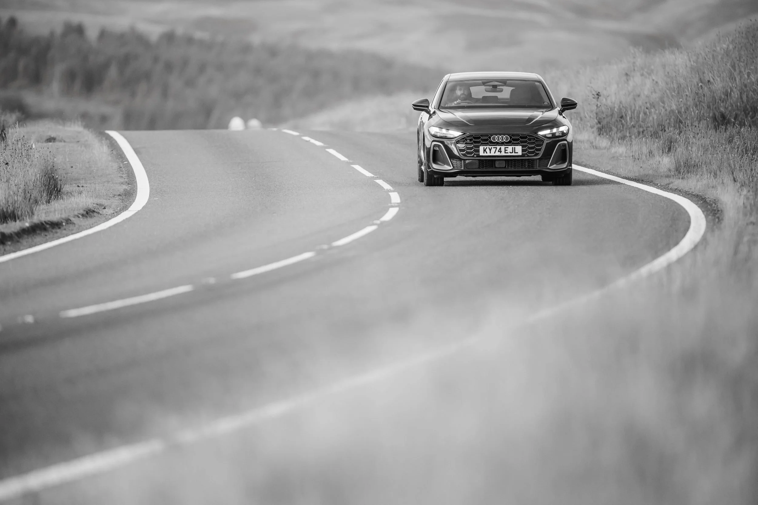Audi rounding a bend on a mountain road, Wales