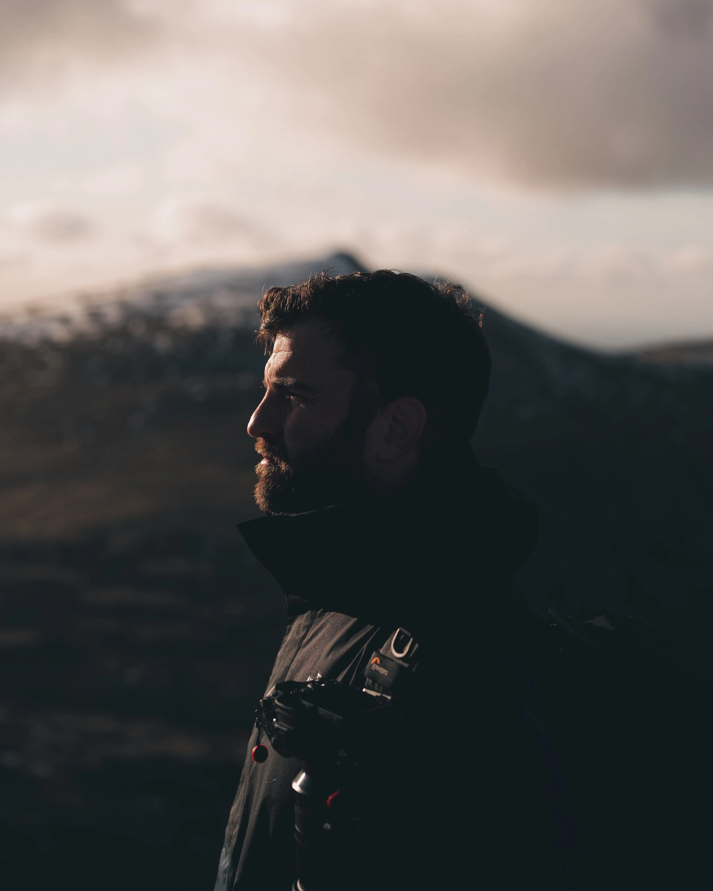Portrait of a man in the mountains at dusk