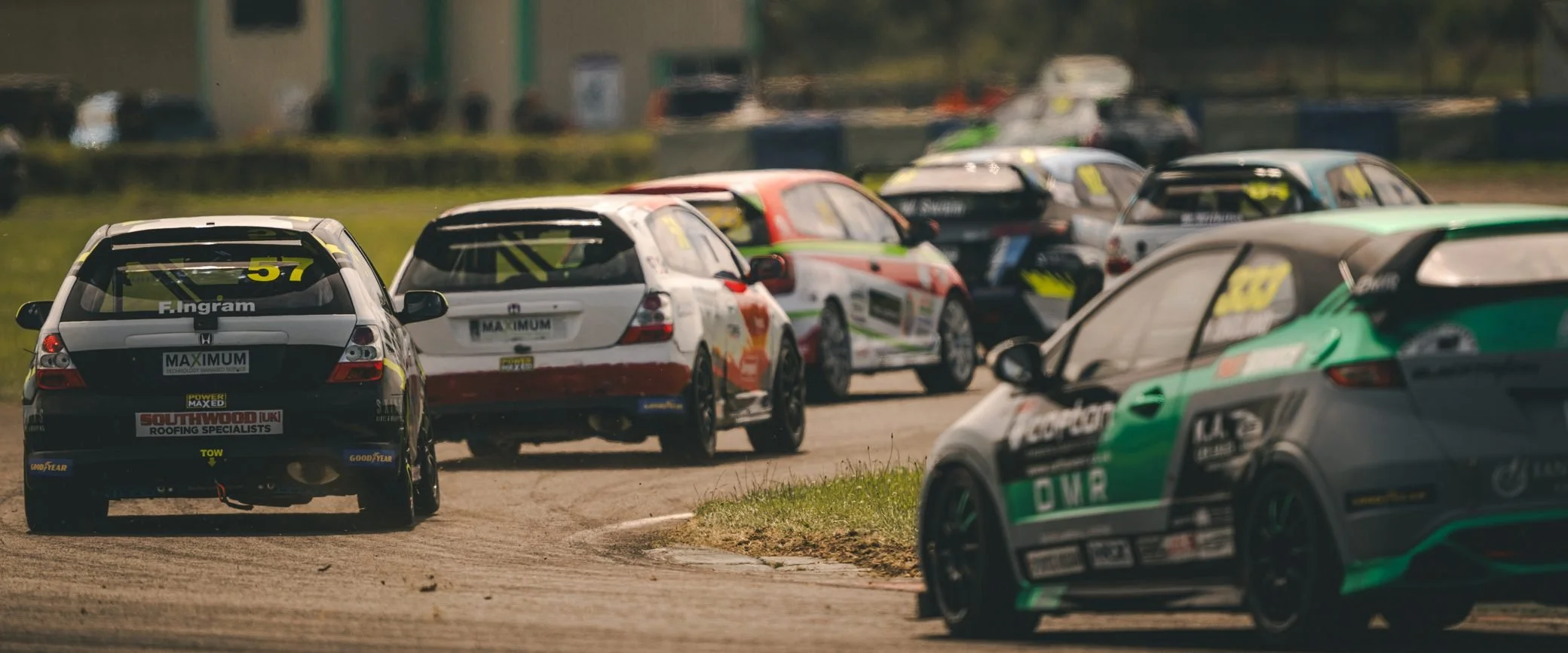 Pack of race cars bunched through a corner, Pembrey Circuit