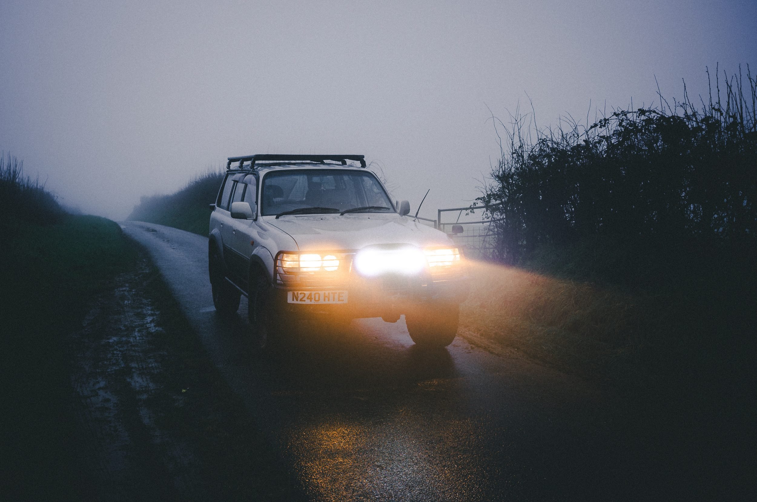 Land Cruiser 80 Series with headlights on in morning fog, Carmarthenshire