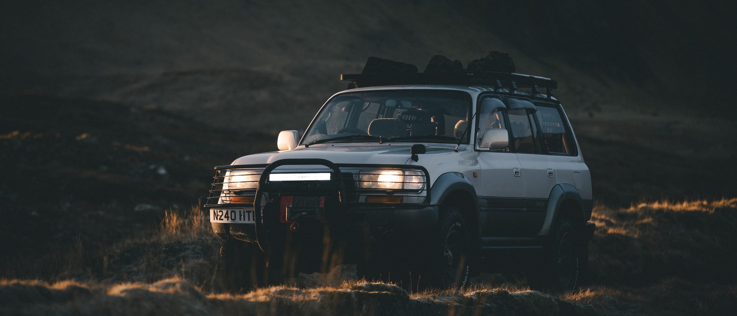 Land Cruiser 80 Series headlights glowing at dusk, Isle of Skye