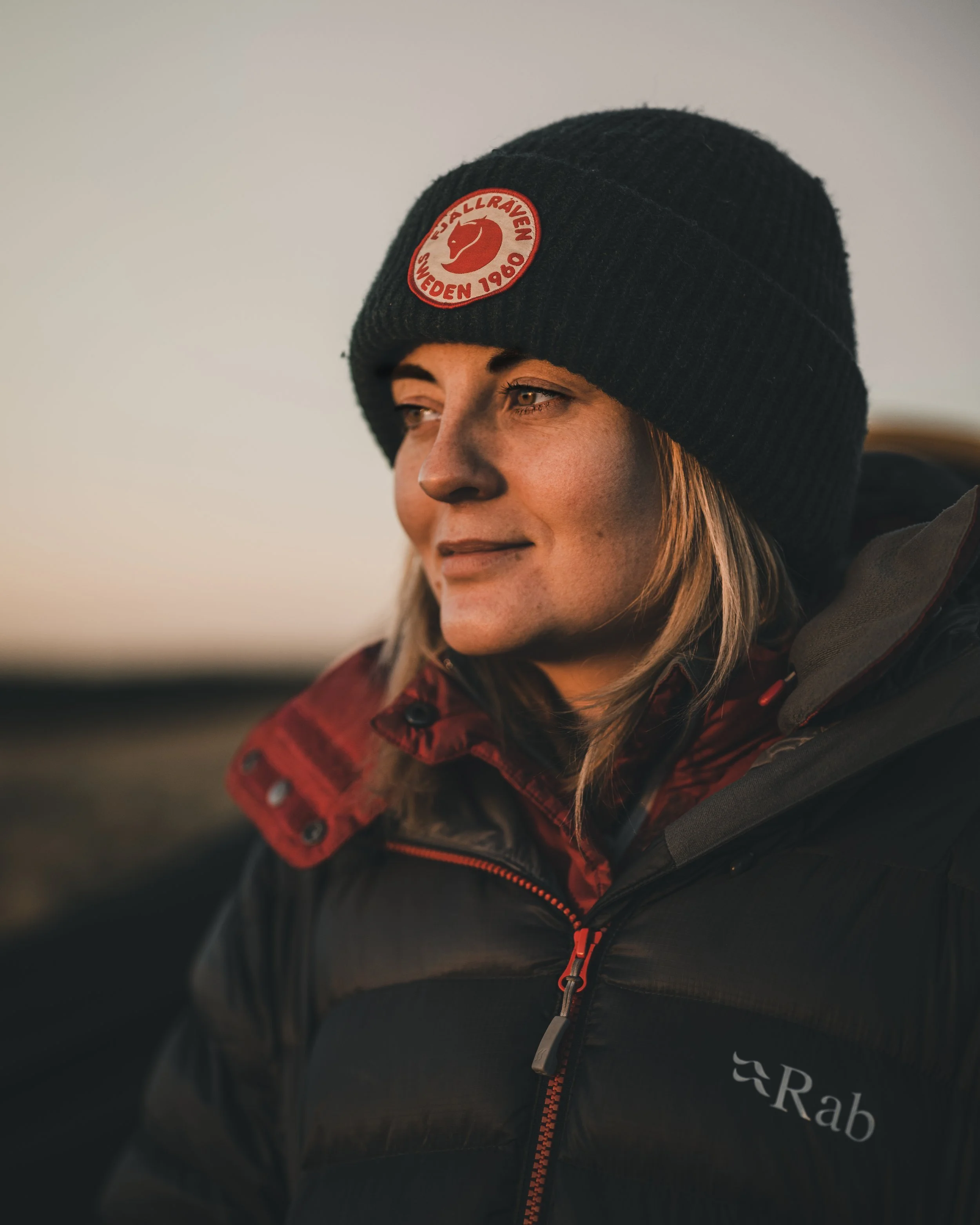 Portrait of a woman in a beanie hat at golden hour