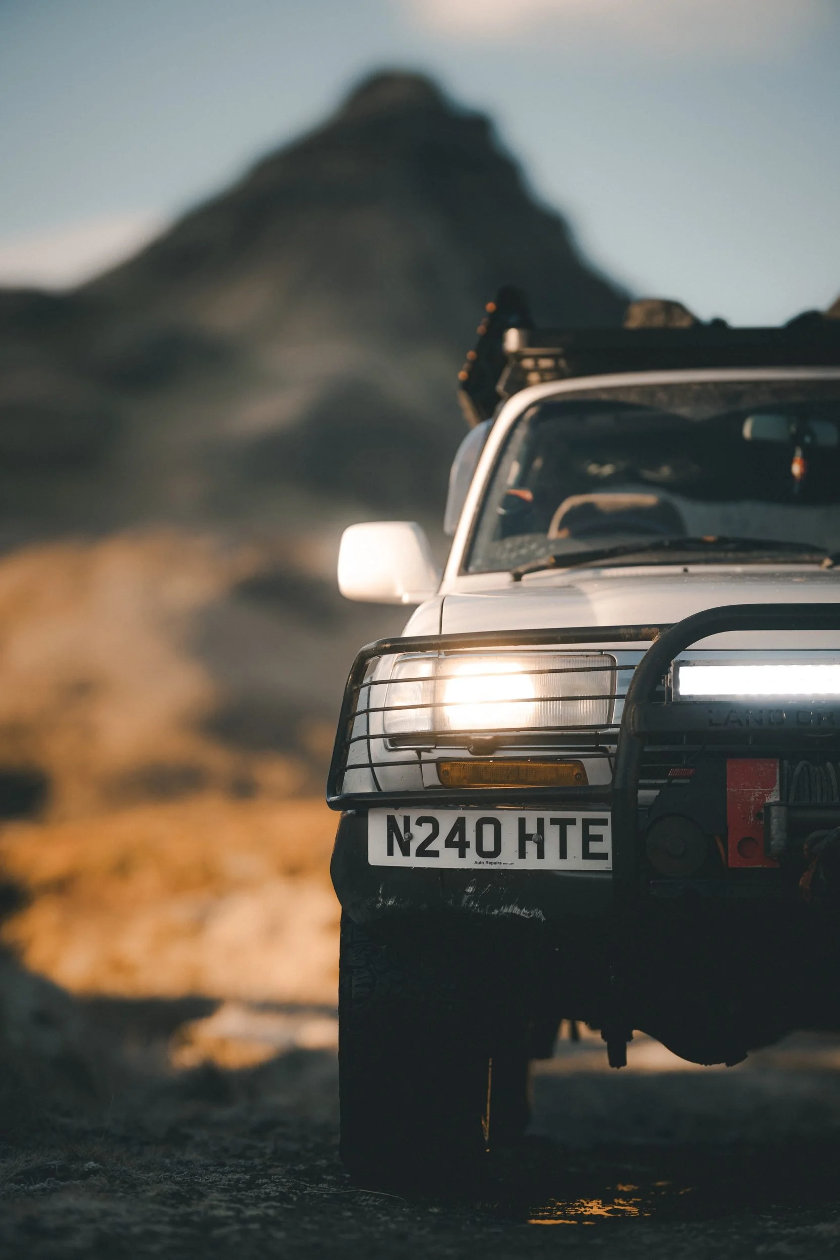 Low view of a Land Cruiser 80 Series with its lights on, Hill of the Red Fox, Isle of Skye