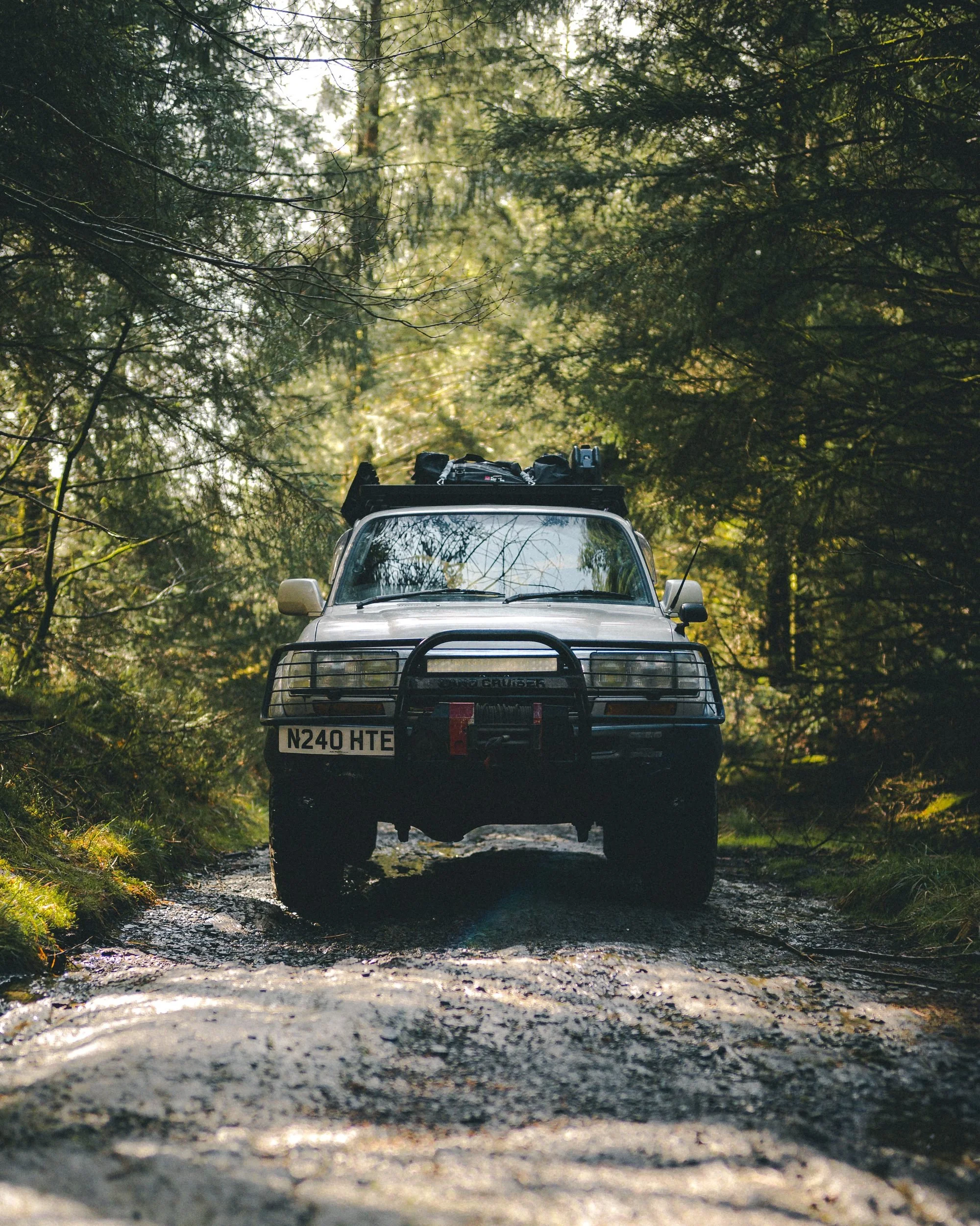 Land Cruiser 80 Series on a muddy forest trail, Powys