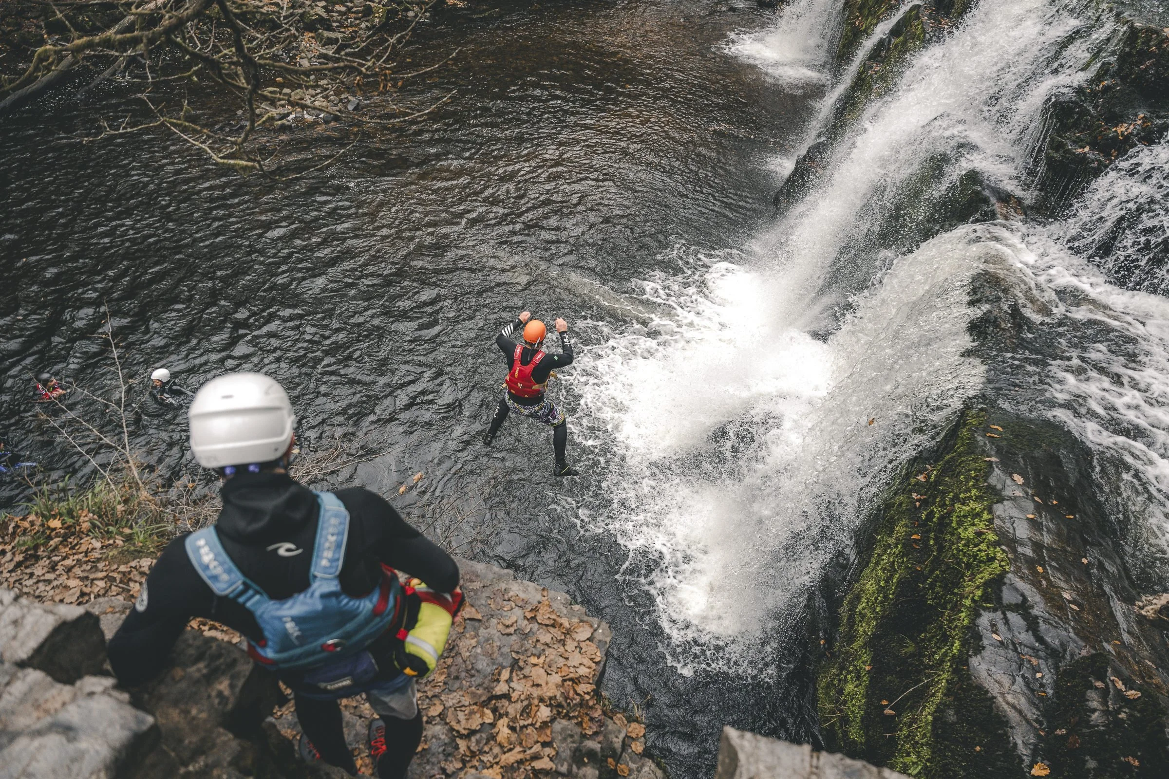 Gorge walker jumping beside a waterfall on the Afon Mellte