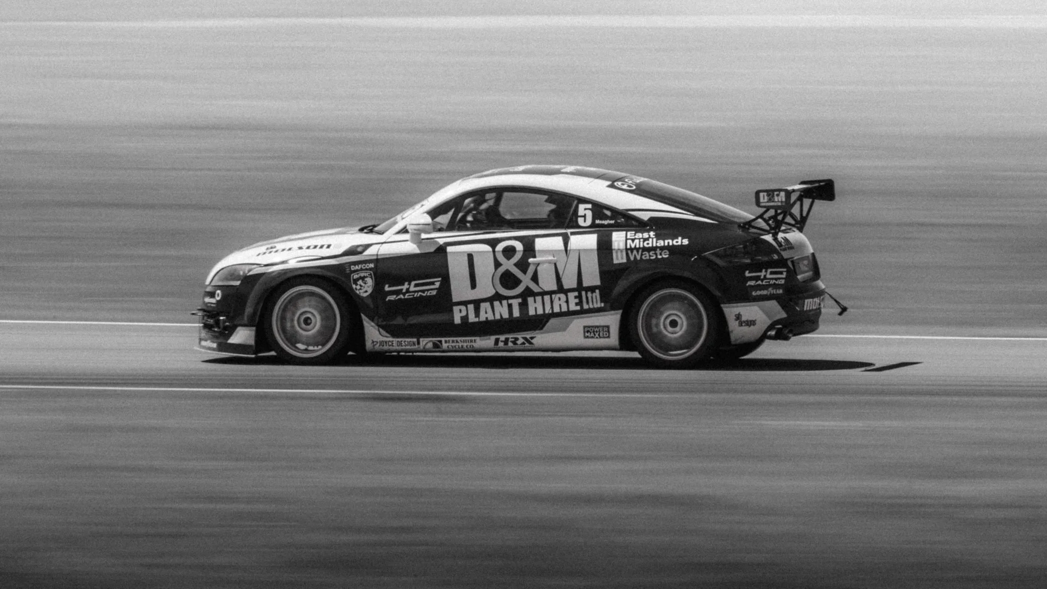 Race car panning shot in black and white, Pembrey Circuit
