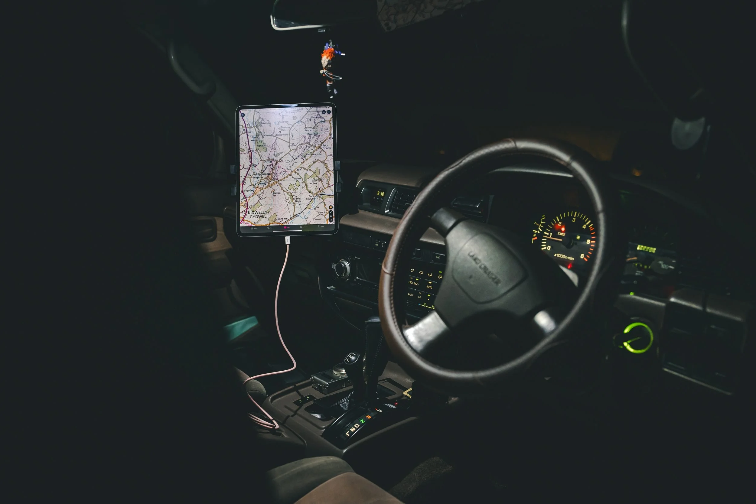 Land Cruiser 80 Series dashboard at night with a map on the screen