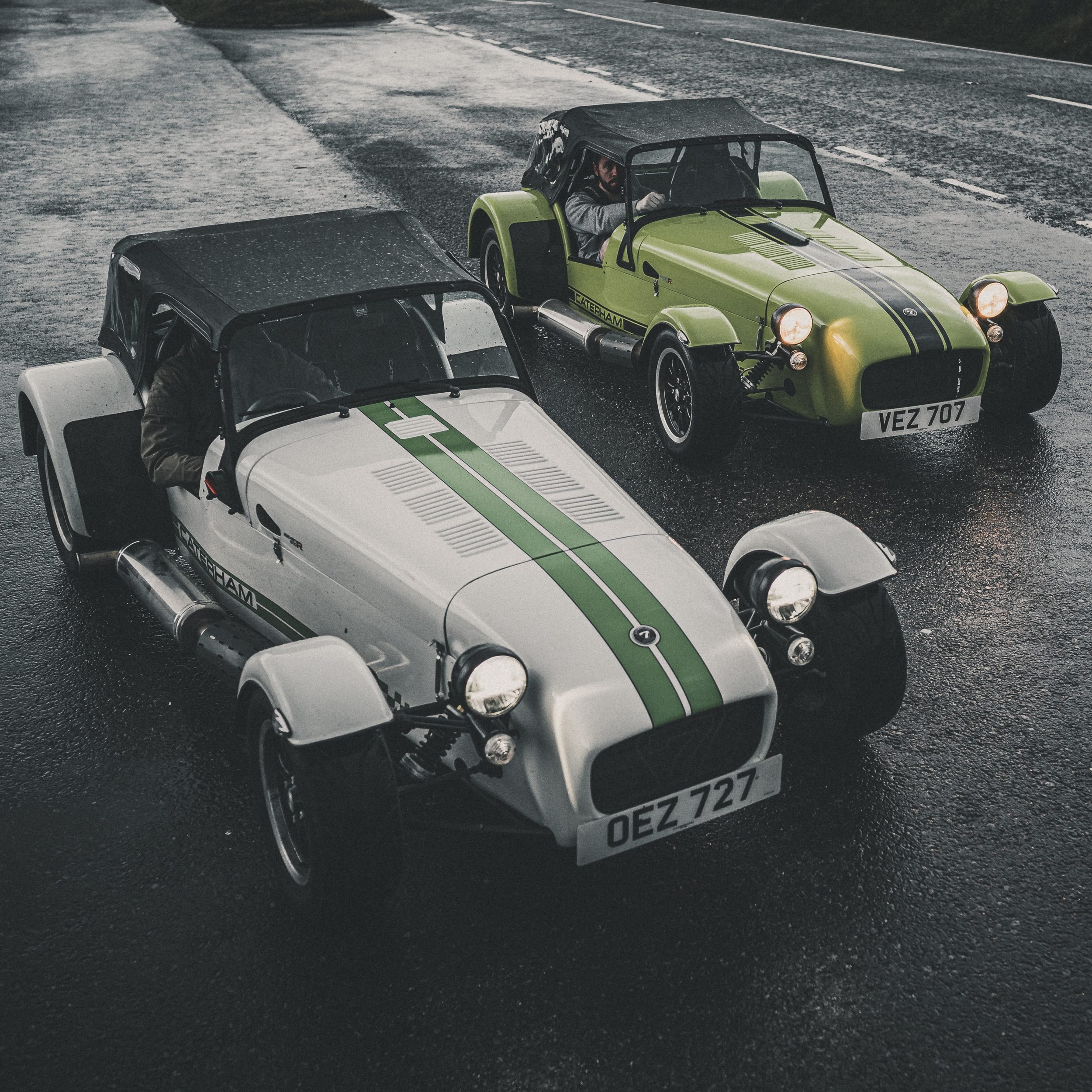 Two Caterham Sevens on a wet road