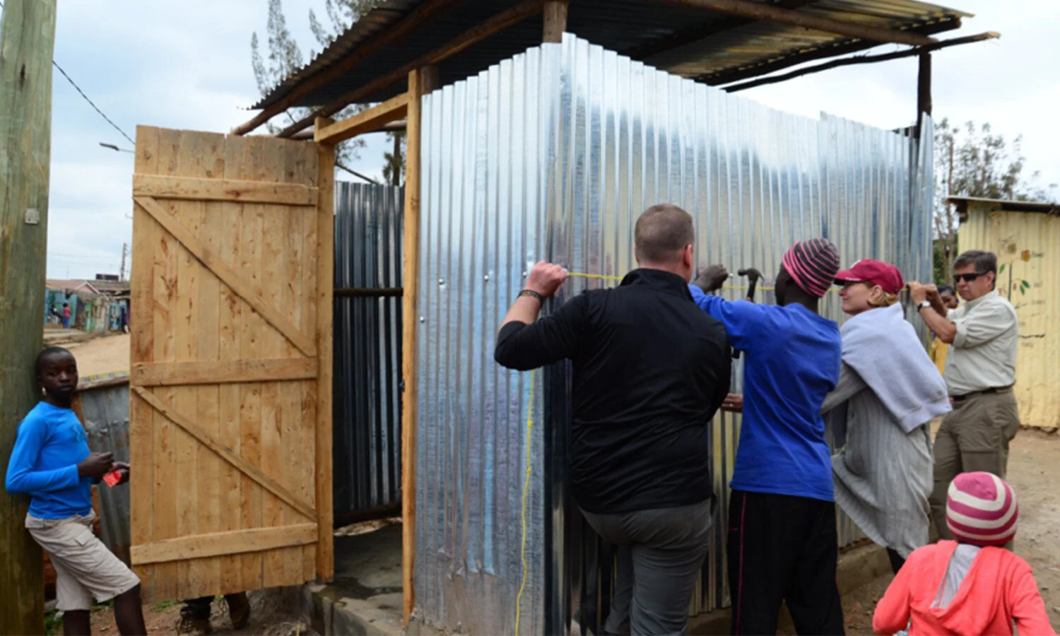   TGE volunteers work on water tank frame for Stemi School.  