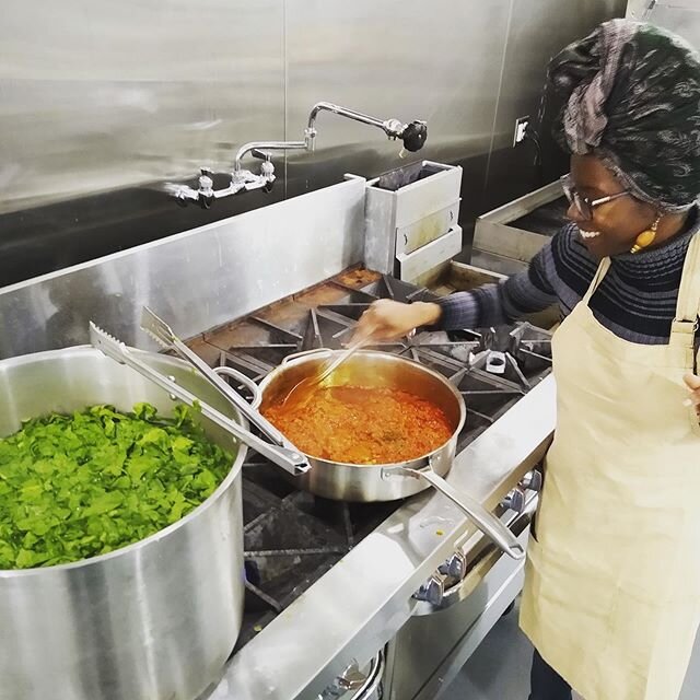 Elsie Kriz of @afrovitalityeats making njama njama (African style saut&eacute;ed turnip greens) and stirring up the tomato base for the riz saut&eacute; a la tomate dish for our popup dinner tonight with @triluna_wellness at the @thegalleryatforthous