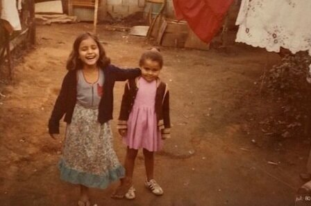  This is me, on the left, at age 7. This photo was taken in the backyard of my childhood home. 