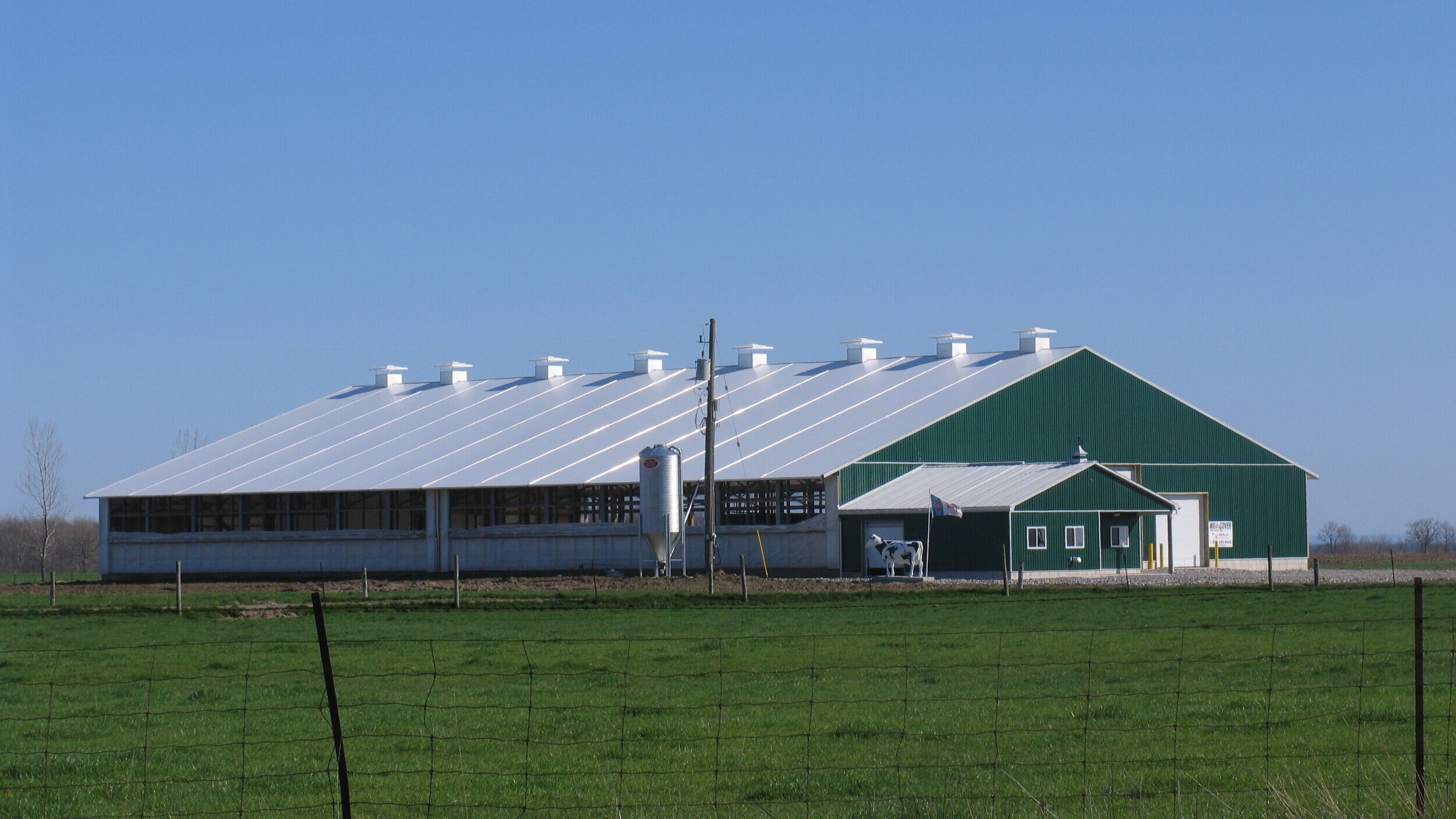 A custom 100’x 204’ fabric roof metal frame dairy barn in Dunville, Ontario.