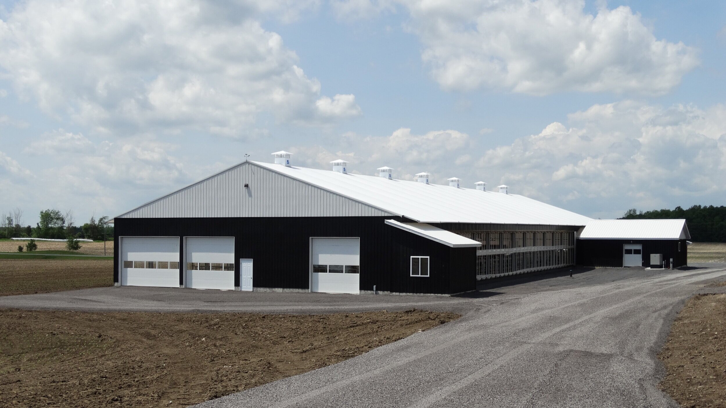 A custom 74’x 210’ fabric roof metal frame dairy barn in Williamstown, Ontario.