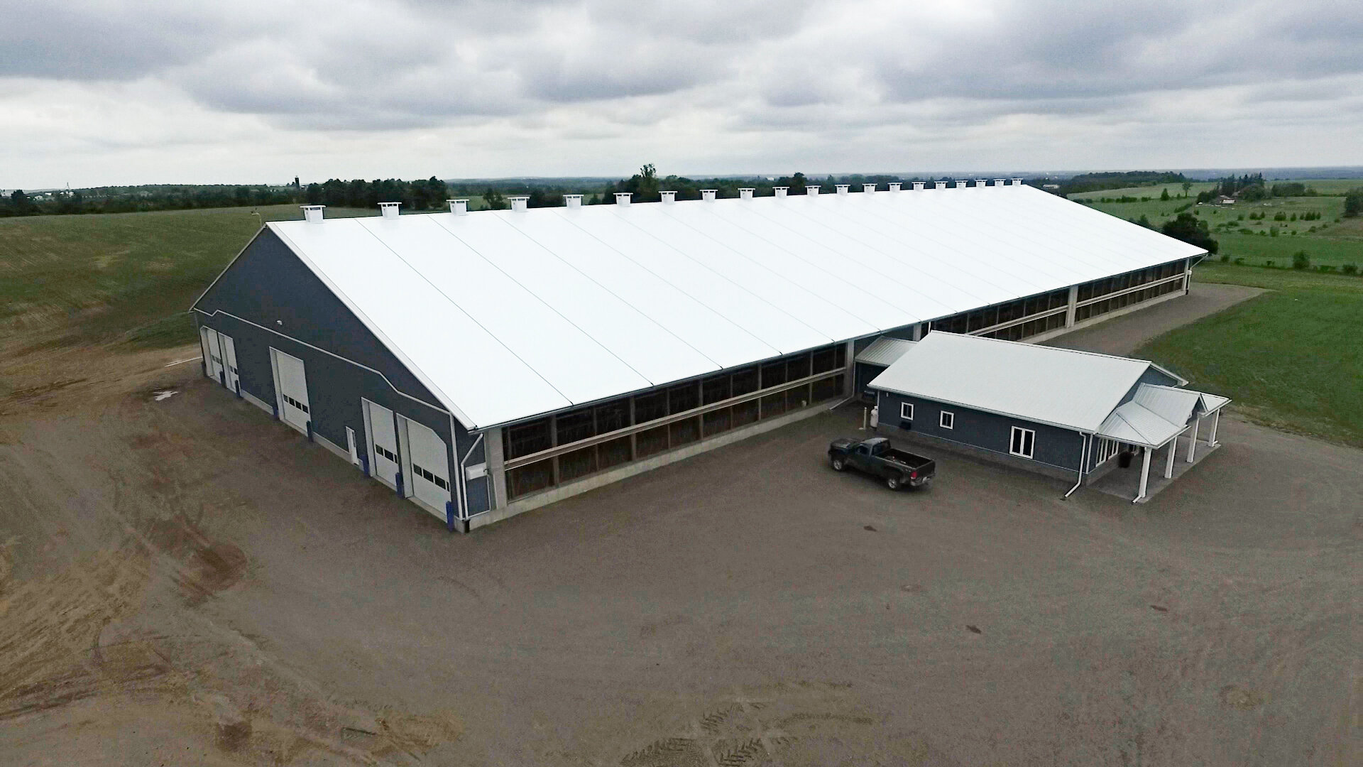 A custom 140’x 322’ fabric roof metal frame dairy barn in Port Perry, Ontario..