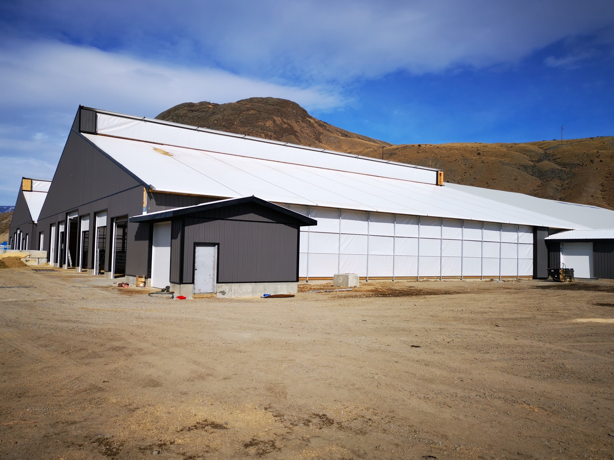 A custom 125’x 318' fabric roof steel frame dairy barn &amp; 96’ x 125’ calf barn in Ashcroft, British Columbia.