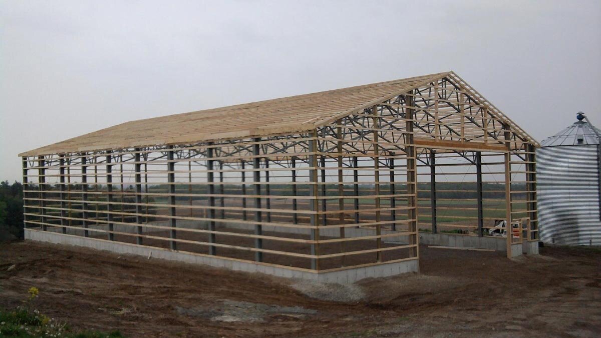  The frame of a  wooden and steel hybrid steel roof barn. 