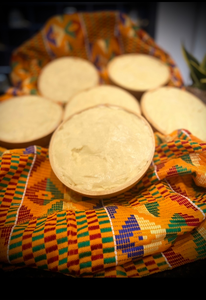 Five halves of a yellowish-white root vegetable, possibly yuca or cassava, placed on a colorful, patterned cloth.