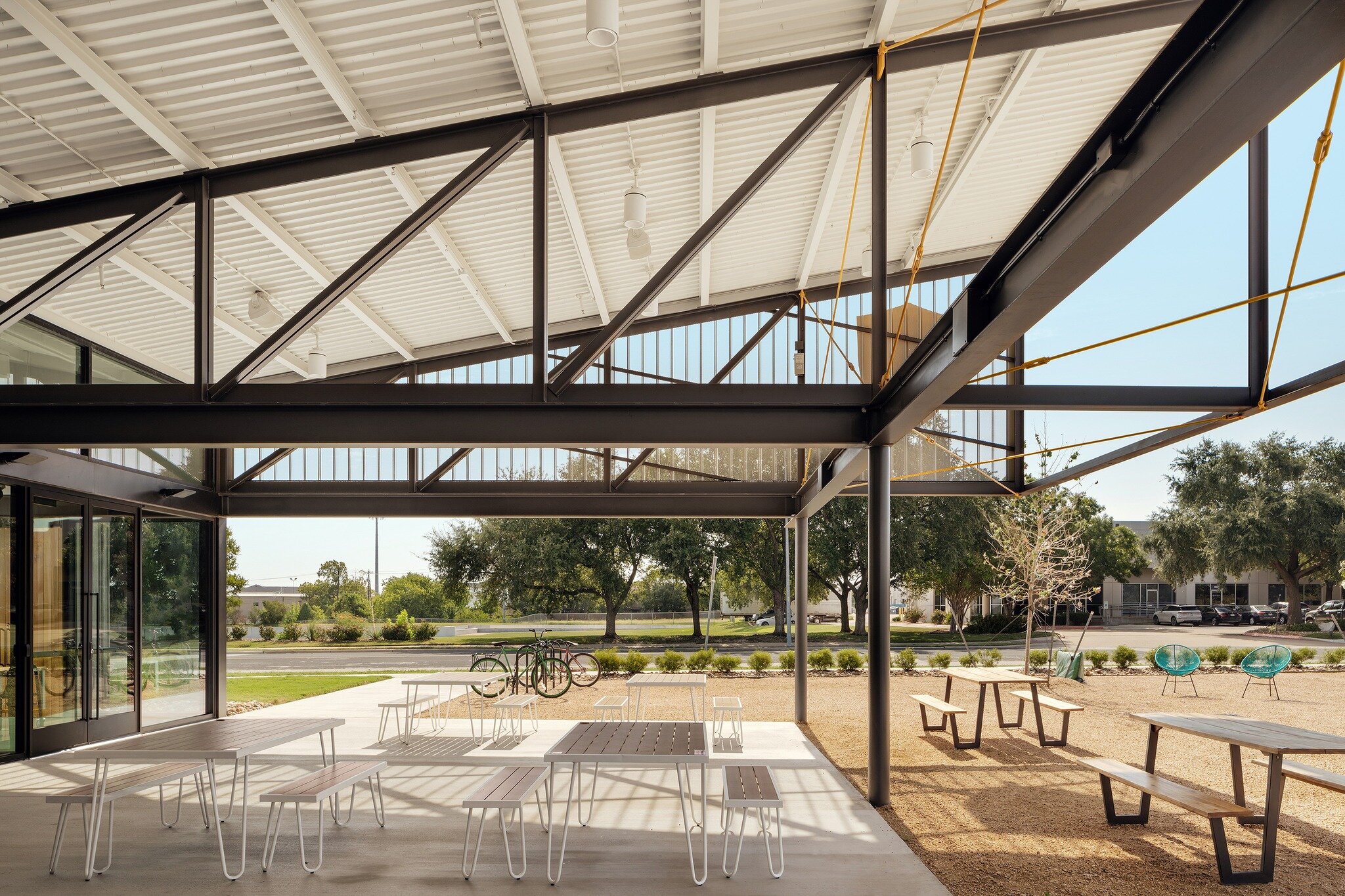 Ghostline Kitchens - Covered patio flex space used for outdoor dining, coffee breaks, and moments of fresh-air , effectively doubling the functional square footage of the @ghostlinekitchens demo kitchen and lobby space. 

#industrialarchitecture #res