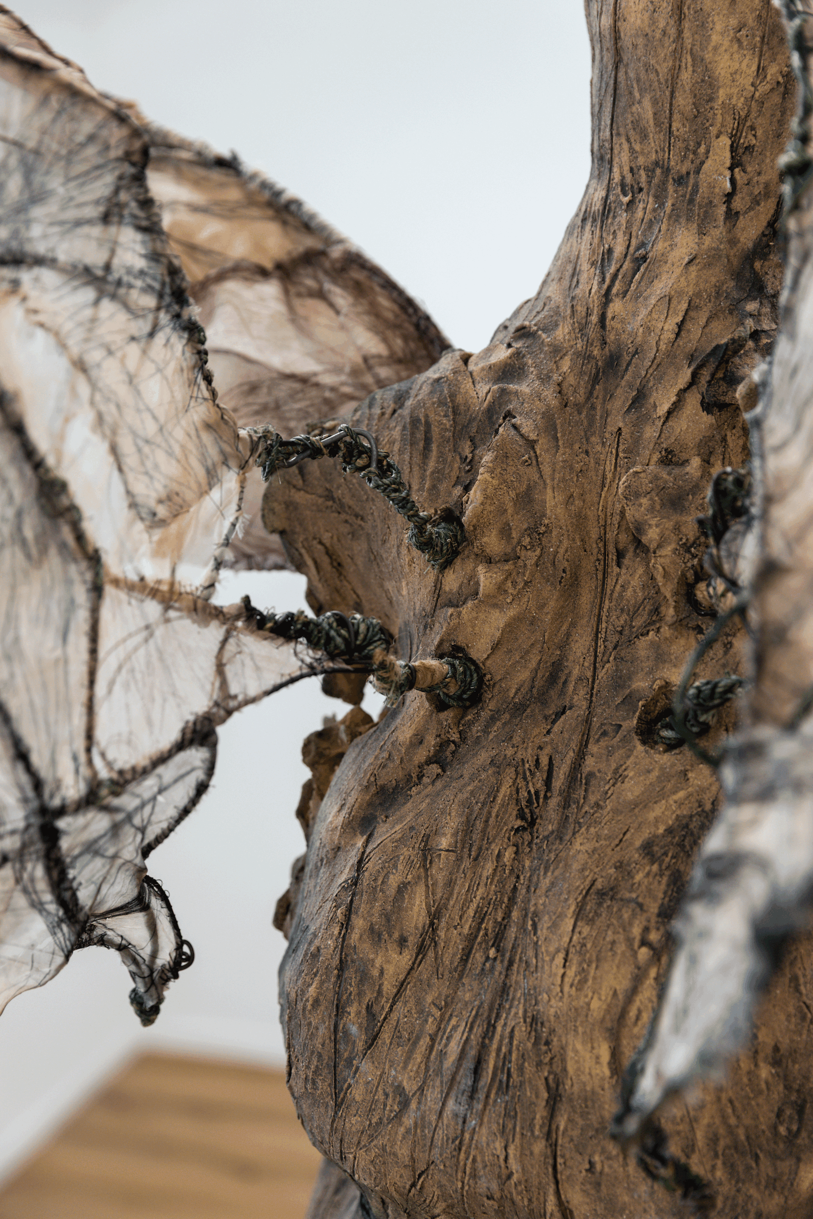 “Winged Figure”, Christina Y. Fesmire, Nguyen Ly, Ceramic, Drypoint on Fabric, Tea, Coffee, Hand-Stitching, Blood, Wire, Dimensions Variable, 2025
