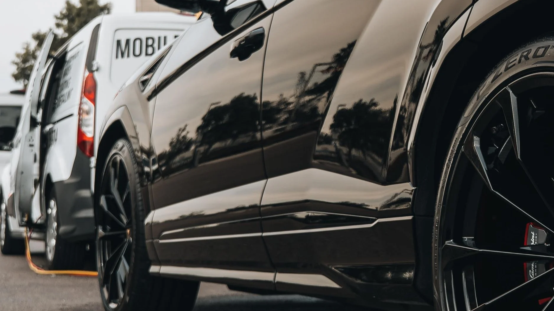 Ceramic coating application on vehicle panel at San Diego driveway location