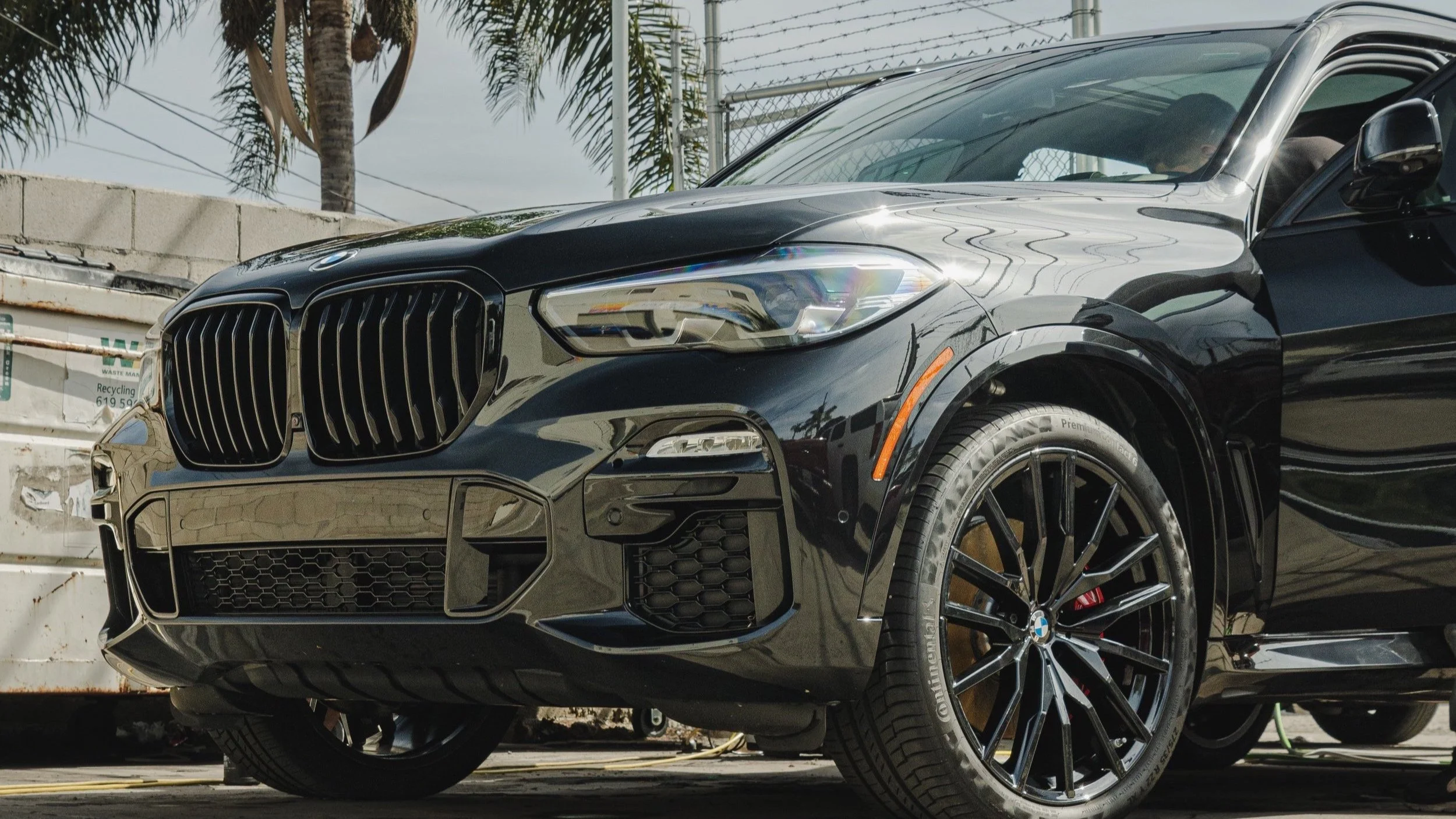 High-mileage daily driver with 100000 miles showing environmental wear on paint surface