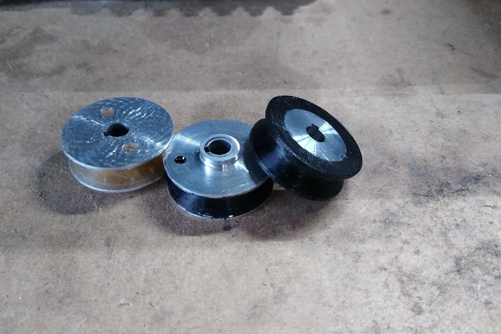 The black urethane is a slightly harder and unfortunately provides less grip. The right most pulley uses an updated core design.