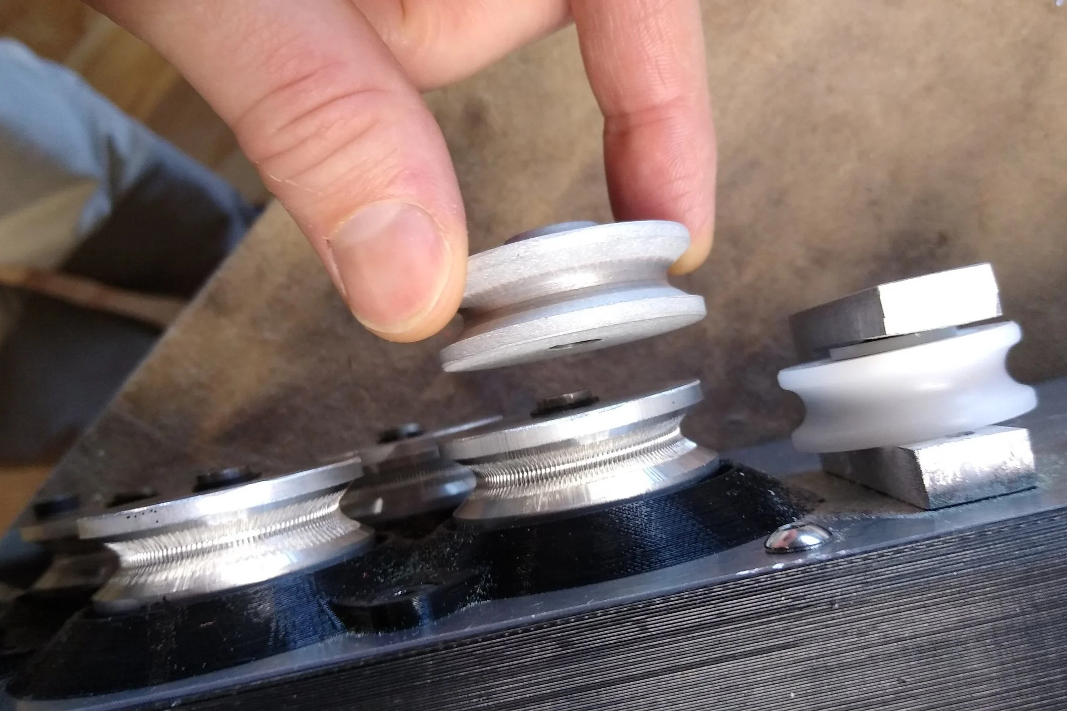 A sandblasted pulley and the first iteration of the knurled pulley.