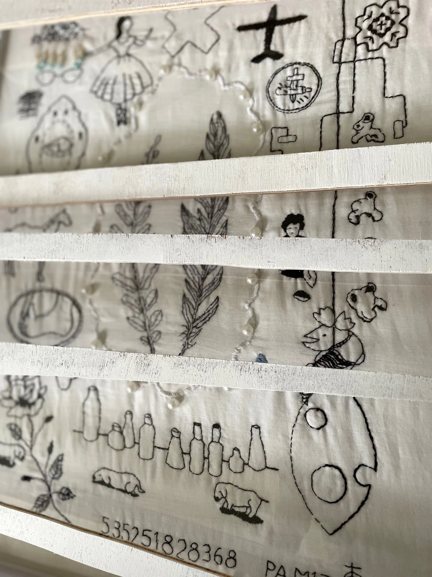 Embroidered items from art collection set in a frame