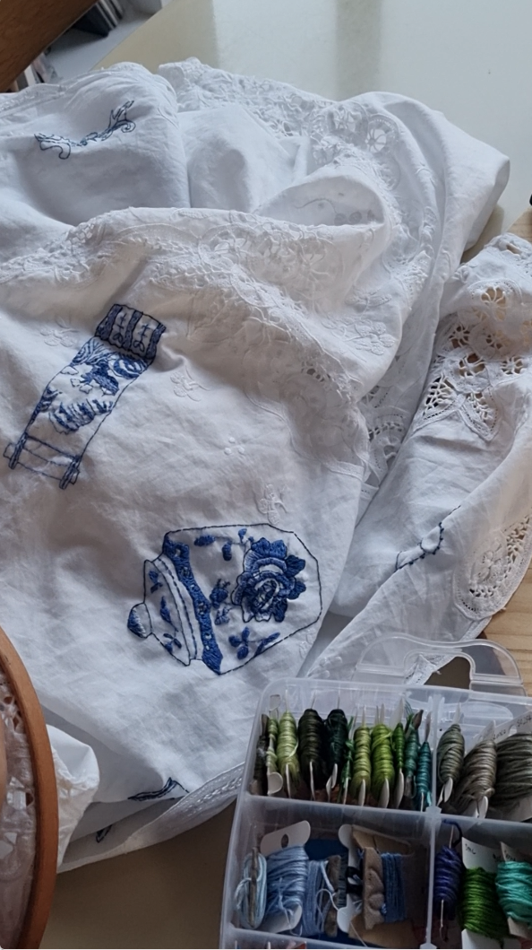 Embroidered table cloth with treasured ceramic heirlooms