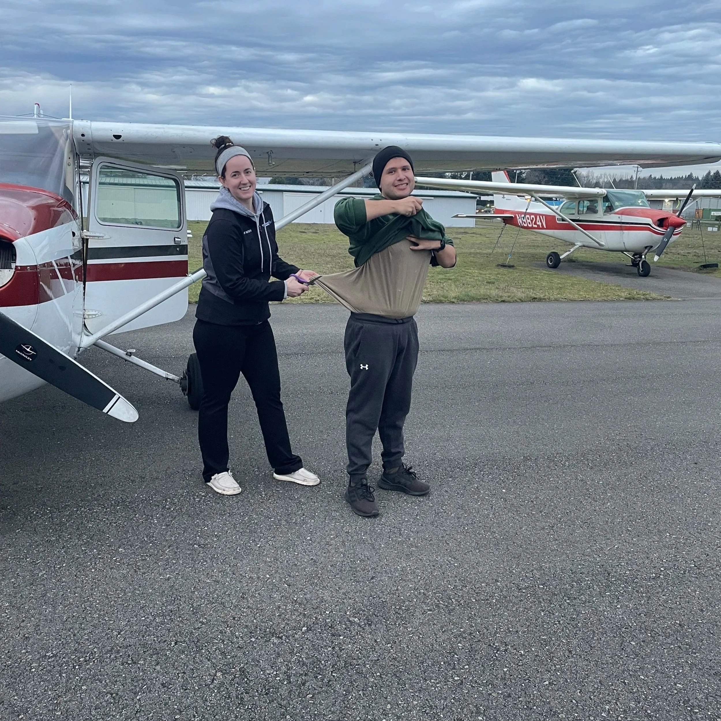The traditional cutting of the shirt for Miguel Villeda's first SOLO flight! By CFI's Camryn Beidler.  Congratulations Miguel!