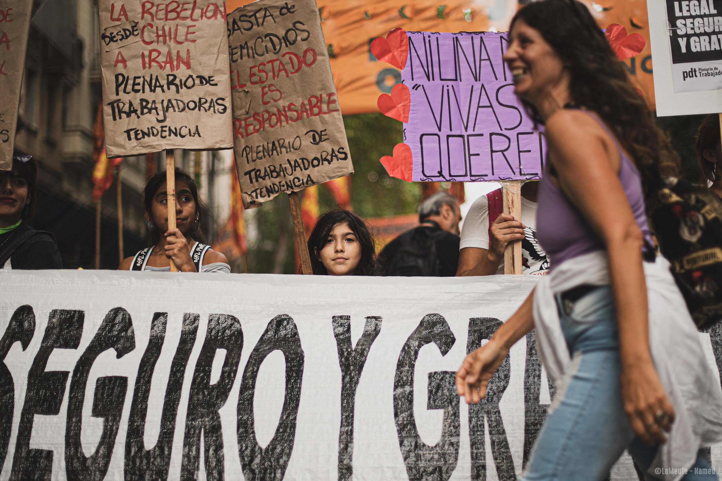   Des jeunes militantes tiennent des pancartes « Stop féminicides », « L'Etat est responsable ».  ©LaMeute – Nameu 