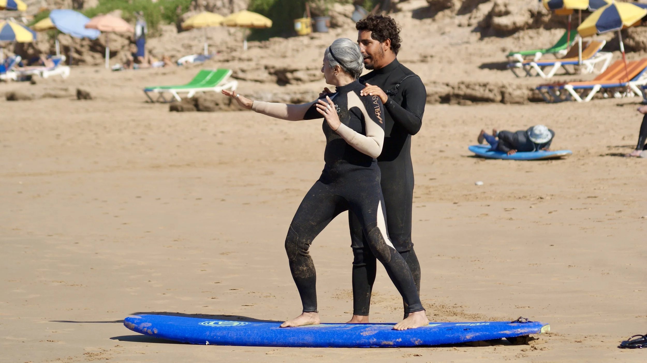 ISA Surf Coach Rachid teaching a 50 year old beginner surfer on Crocros beach, Tamraght, Taghazout Bay, Morocco.