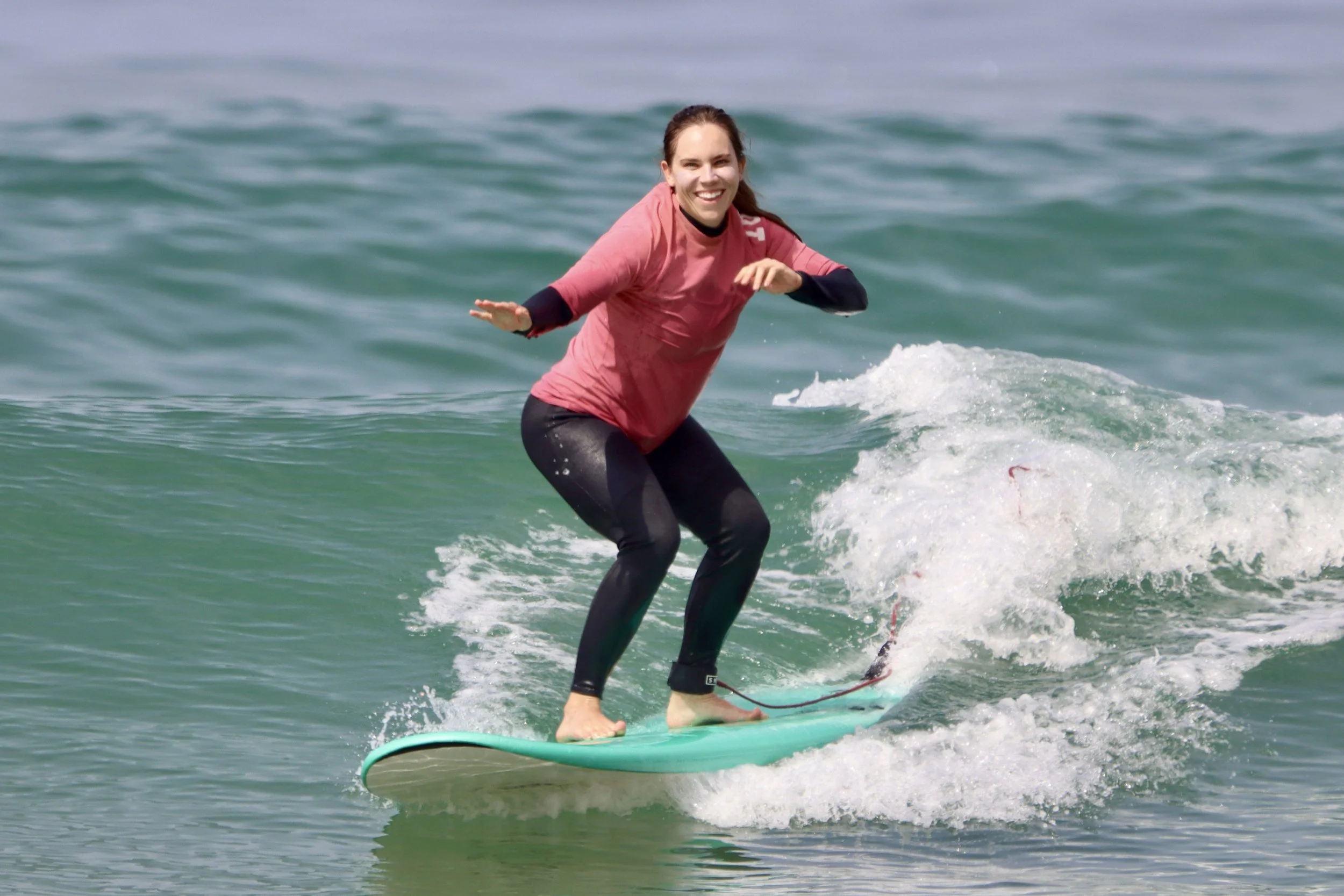An improver surfer learning to ride green waves consistently after balance improves surfing Taghazout Bay, Morocco.