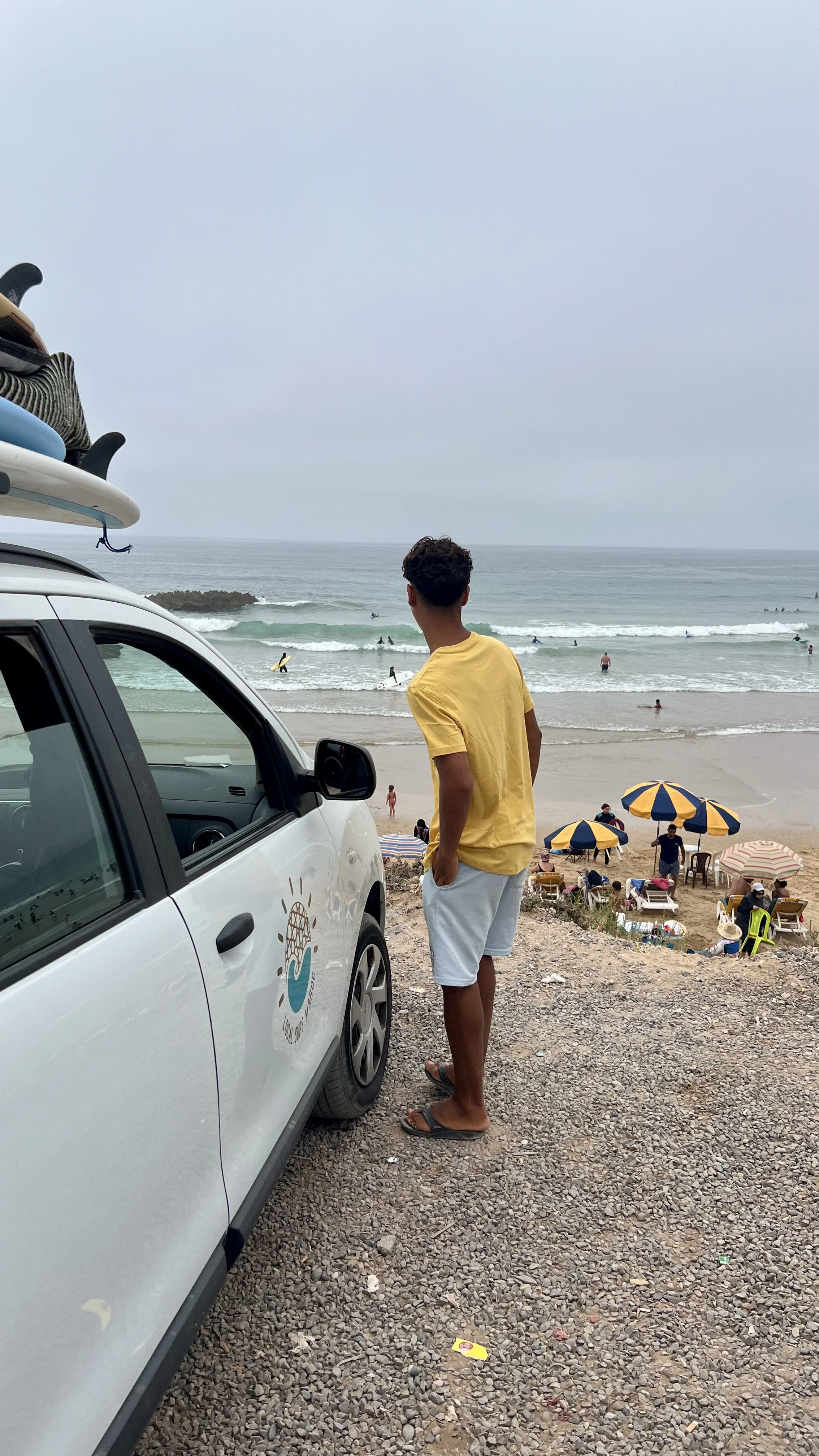 Local Surf Maroc surf guide checking wave conditions before a surf session at Crocros, Tamraght, Taghazout Bay, Morocco.